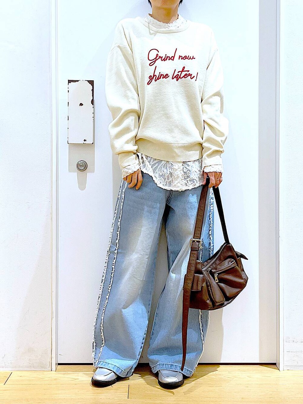 シルバー系のローファー、ブラウン系のショルダーバッグ、ホワイト系のニット/セーターを着用したレディースの春コーディネートの6枚目の写真