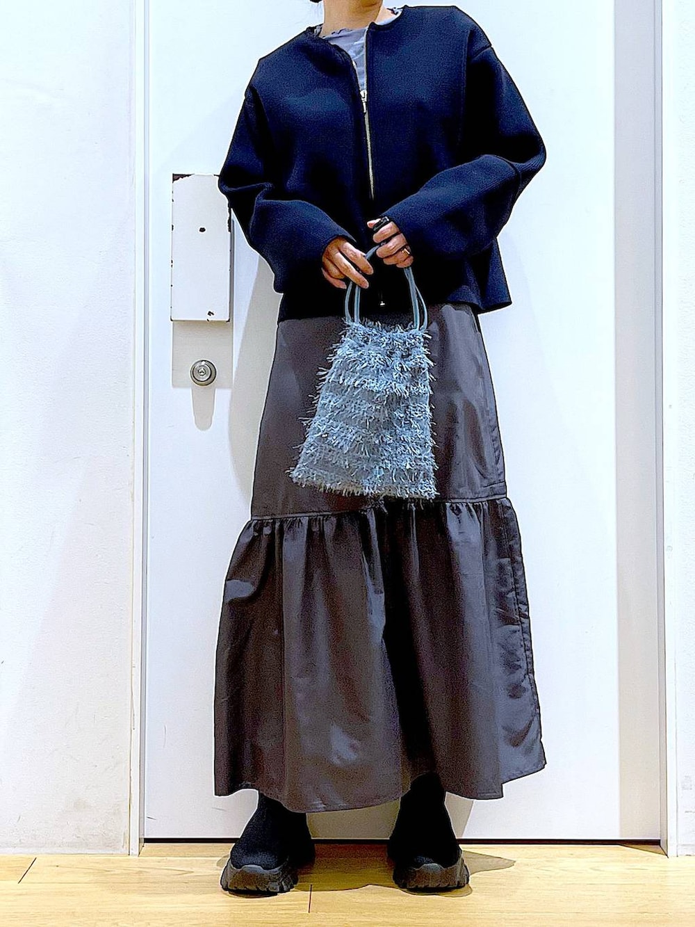 ブルー系のTシャツ/カットソー、ブラック系のブーツ、ブルー系のショルダーバッグを着用したレディースの春コーディネートの6枚目の写真