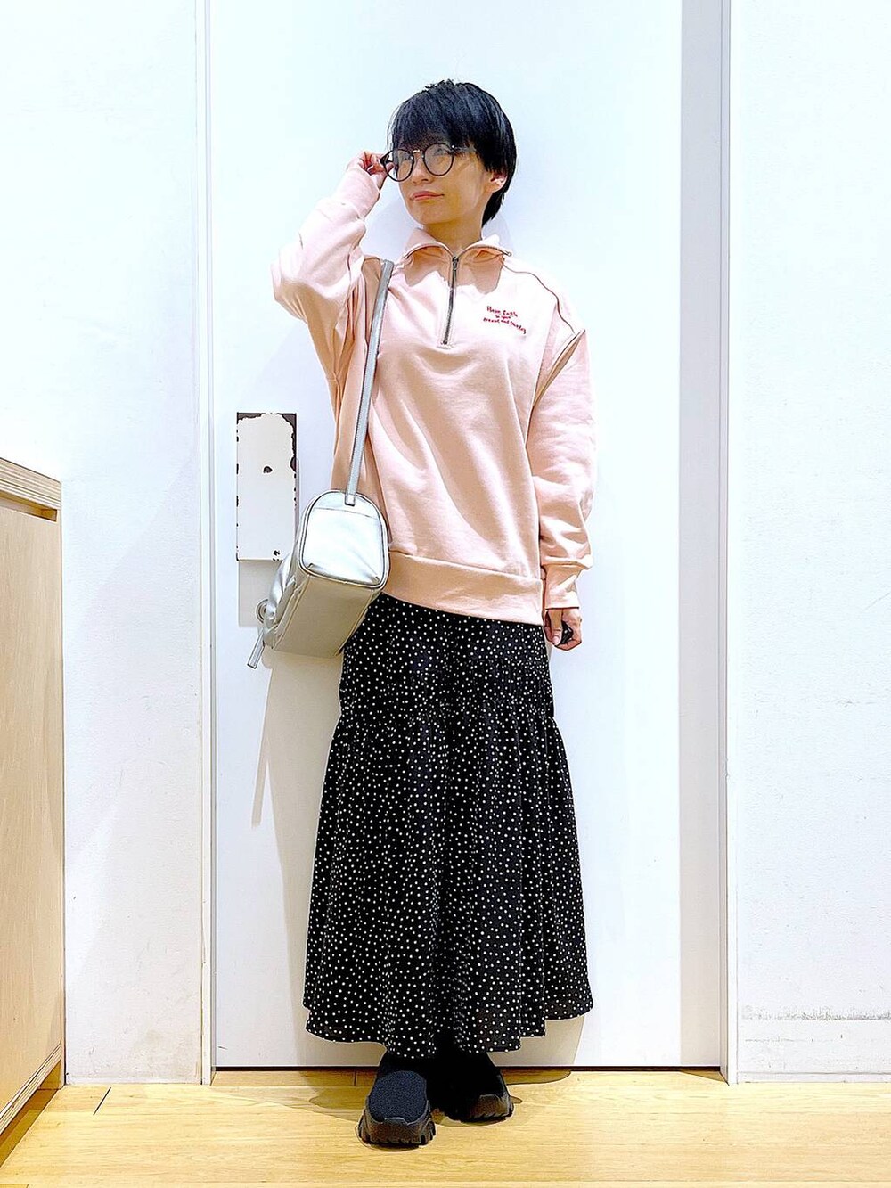 ブラック系のブーツ、シルバー系のショルダーバッグ、その他のスカートを着用したレディースの冬コーディネートの2枚目の写真