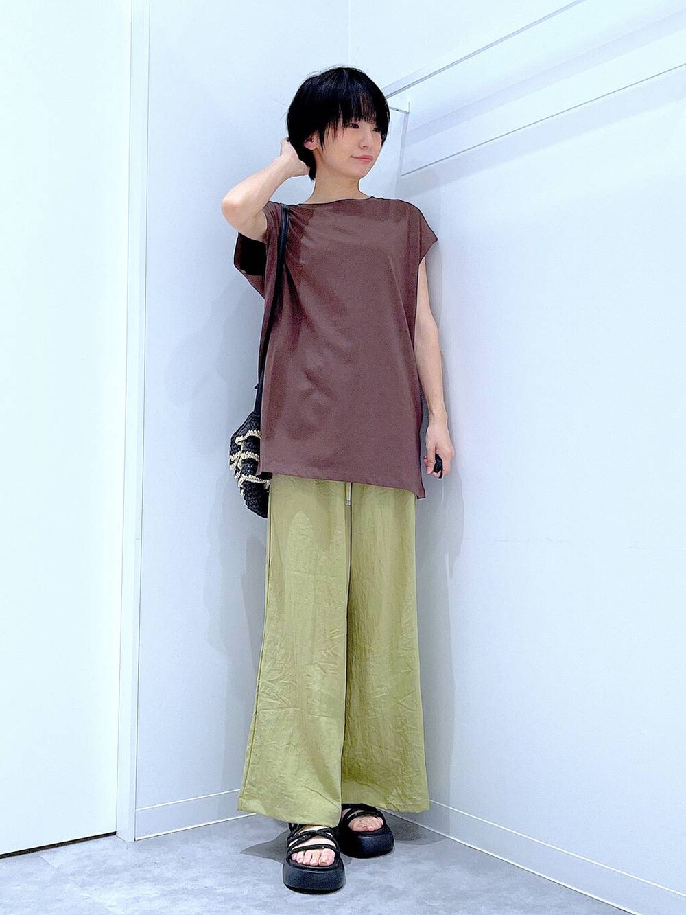 ブラック系のショルダーバッグ、ブラック系のサンダル、グリーン系のその他パンツを着用したレディースの夏コーディネートの2枚目の写真