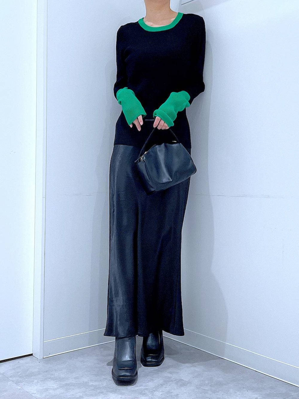 ブラック系のブーツ、ブラック系のショルダーバッグ、ブラック系のニット/セーターを着用したレディースの冬コーディネートの6枚目の写真