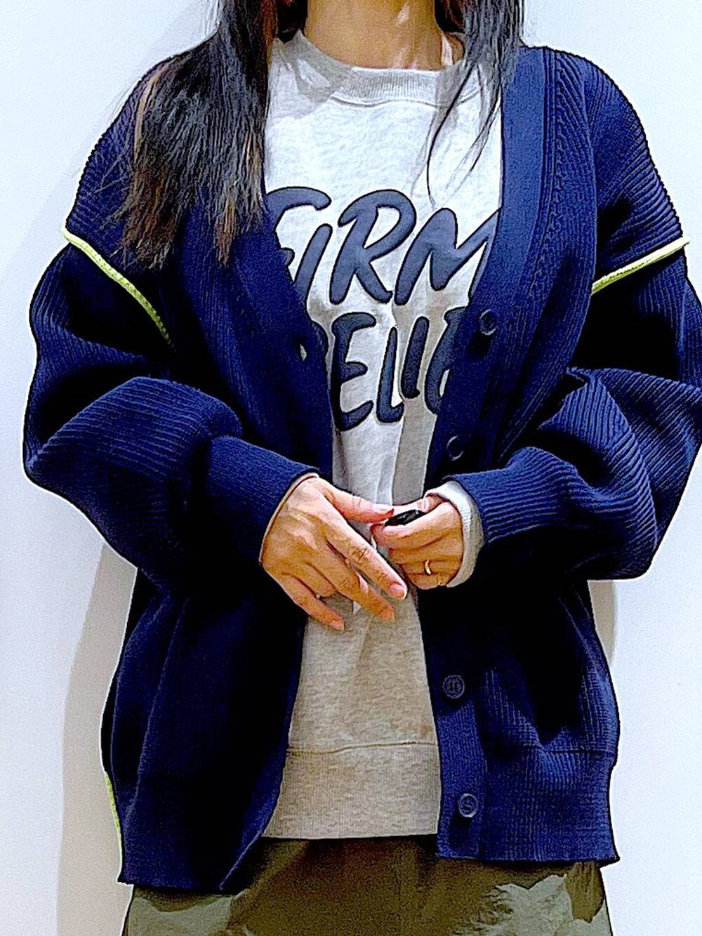 グレー系のスウェット、ブラック系のブーツ、グリーン系のスカートを着用したレディースの冬コーディネートの7枚目の写真