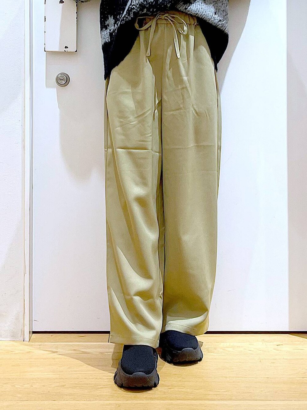 ブラック系のショルダーバッグ、ブラック系のブーツ、イエロー系のその他パンツを着用したレディースの冬コーディネートの8枚目の写真