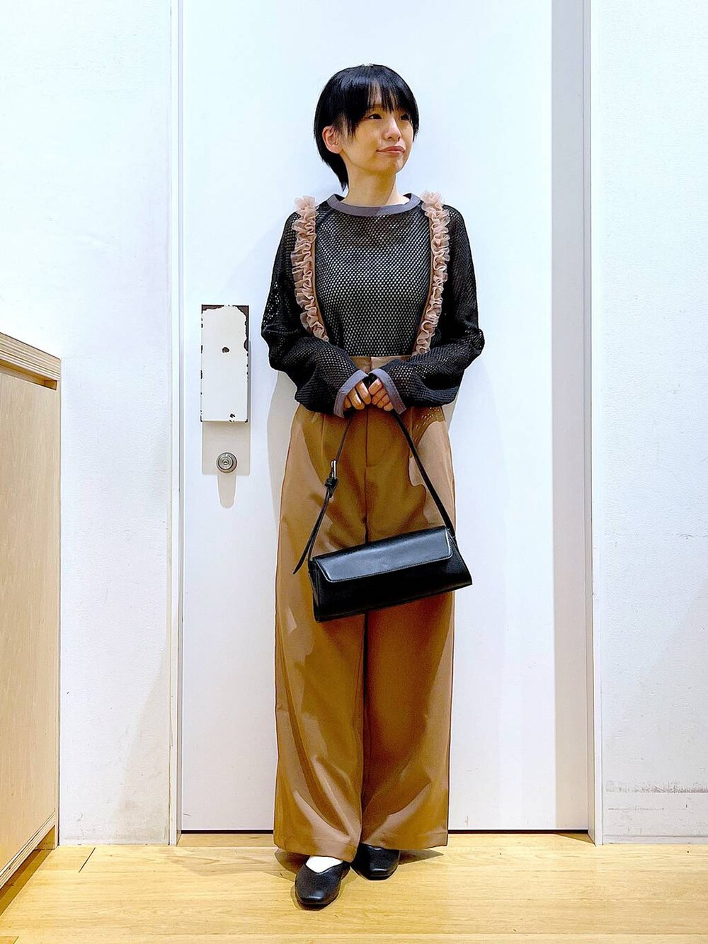 ブラック系のパンプス、ブラック系のショルダーバッグ、ブラウン系のその他パンツを着用したレディースの夏コーディネートの2枚目の写真