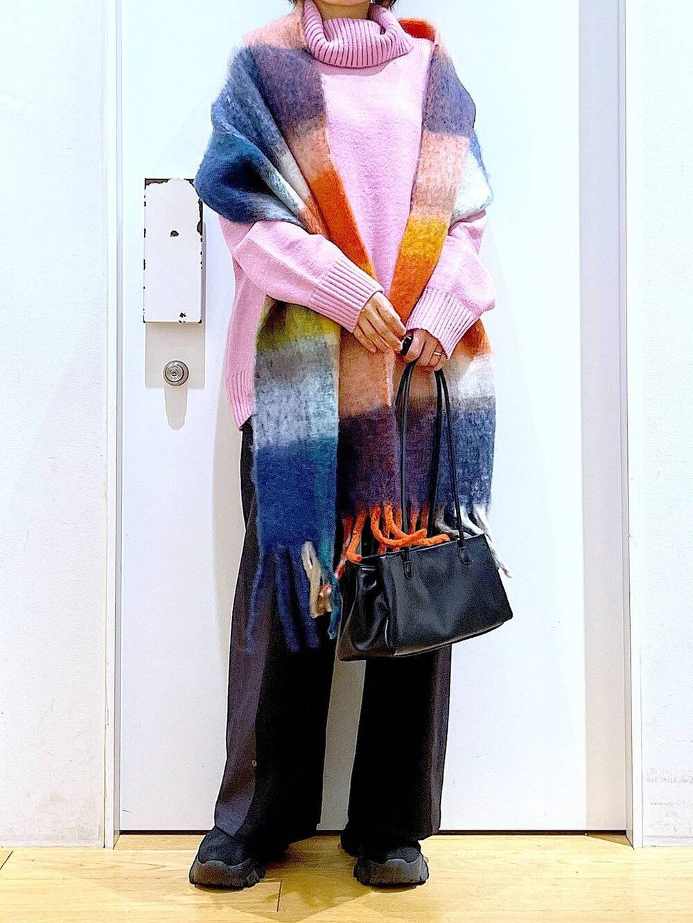 ブラック系のトートバッグ、ブラック系のブーツ、ブラック系のその他パンツを着用したレディースの冬コーディネートの6枚目の写真