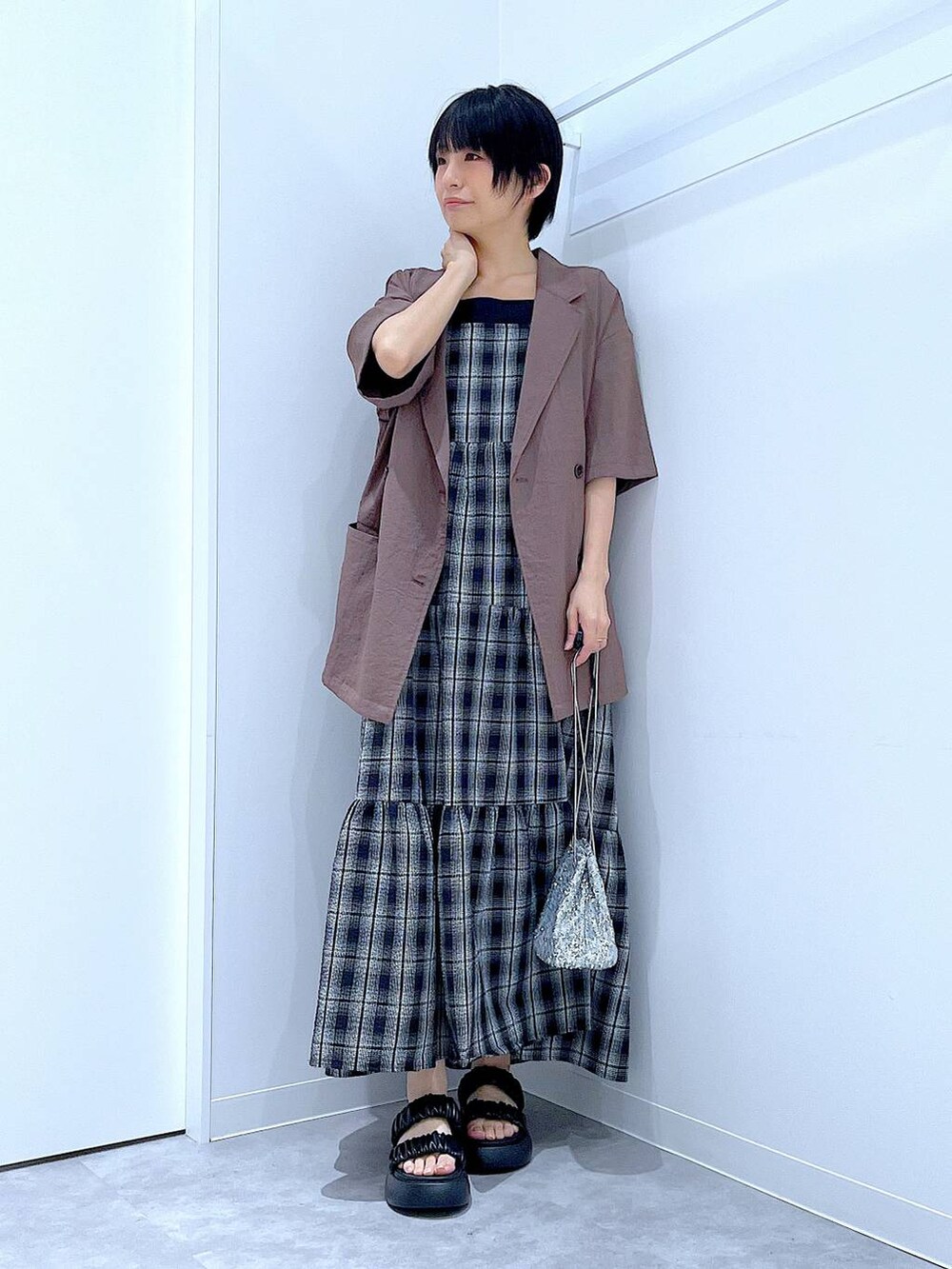 ブラック系のサンダル、シルバー系のショルダーバッグ、ブラウン系のテーラードジャケットを着用したレディースの夏コーディネートの2枚目の写真