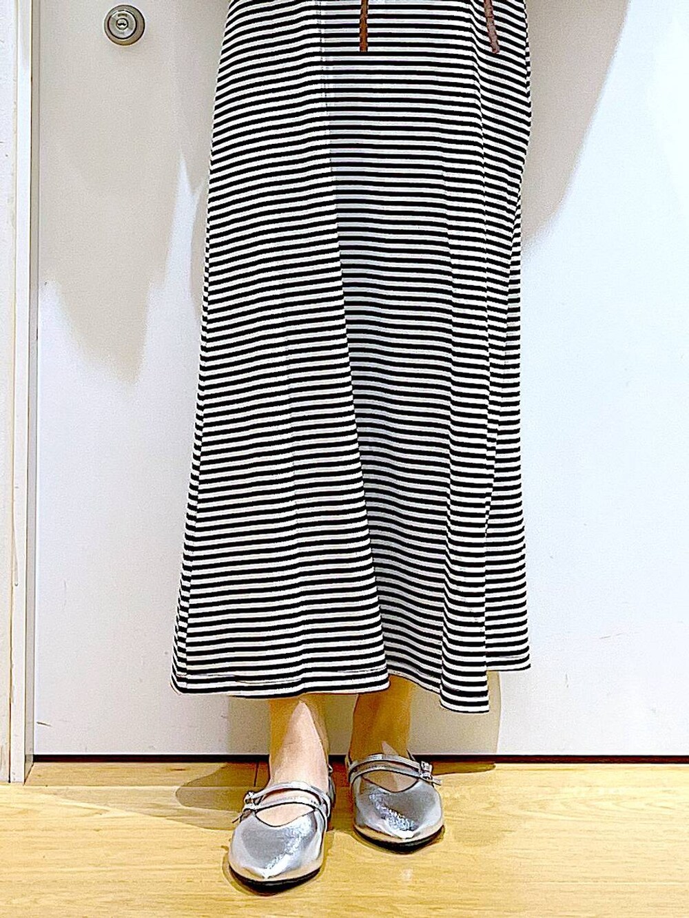 ブラック系のワンピース、シルバー系のパンプス、ブラック系のショルダーバッグを着用したレディースの夏コーディネートの8枚目の写真