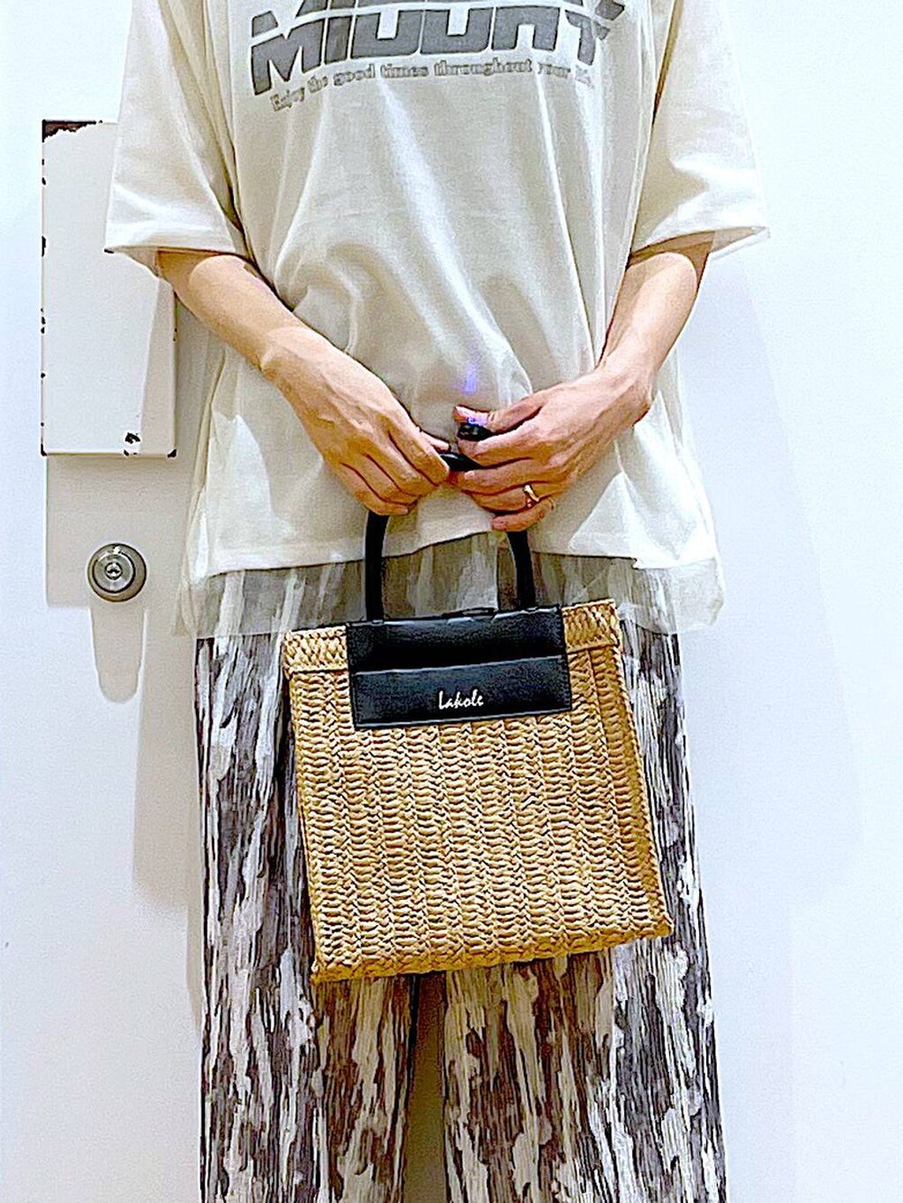 ホワイト系のTシャツ/カットソー、ブラック系のパンプス、ベージュ系のショルダーバッグを着用したレディースの夏コーディネートの9枚目の写真