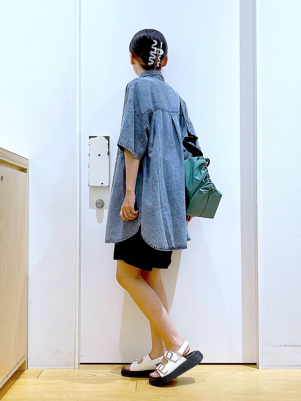 ホワイト系のサンダル、ブラック系のその他パンツ、グリーン系のショルダーバッグを着用したレディースの夏コーディネートの3枚目の写真