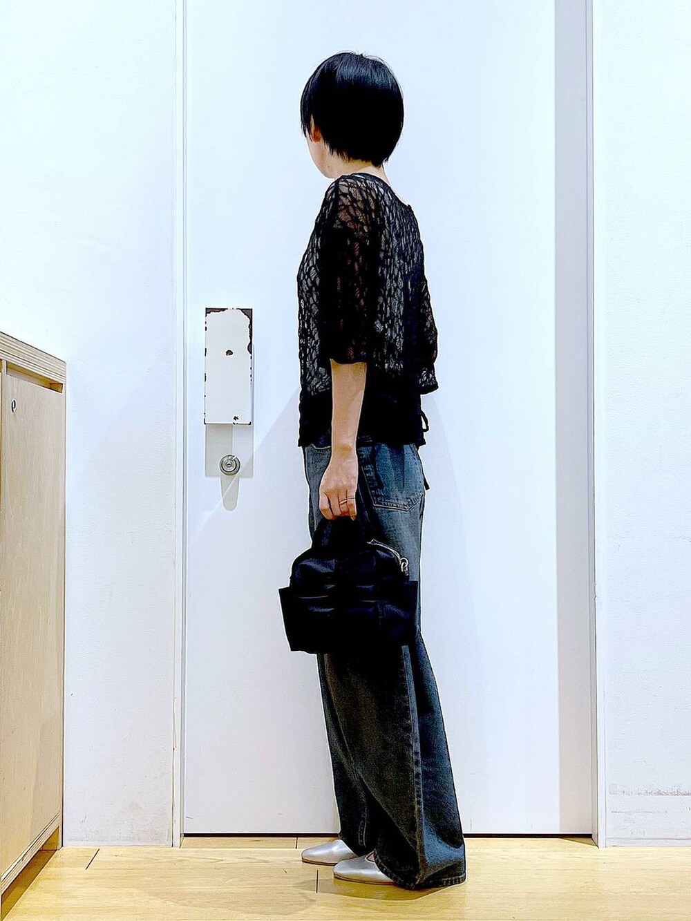 ブルー系のデニムパンツ、シルバー系のパンプス、ブラック系のTシャツ/カットソーを着用したレディースの夏コーディネートの3枚目の写真