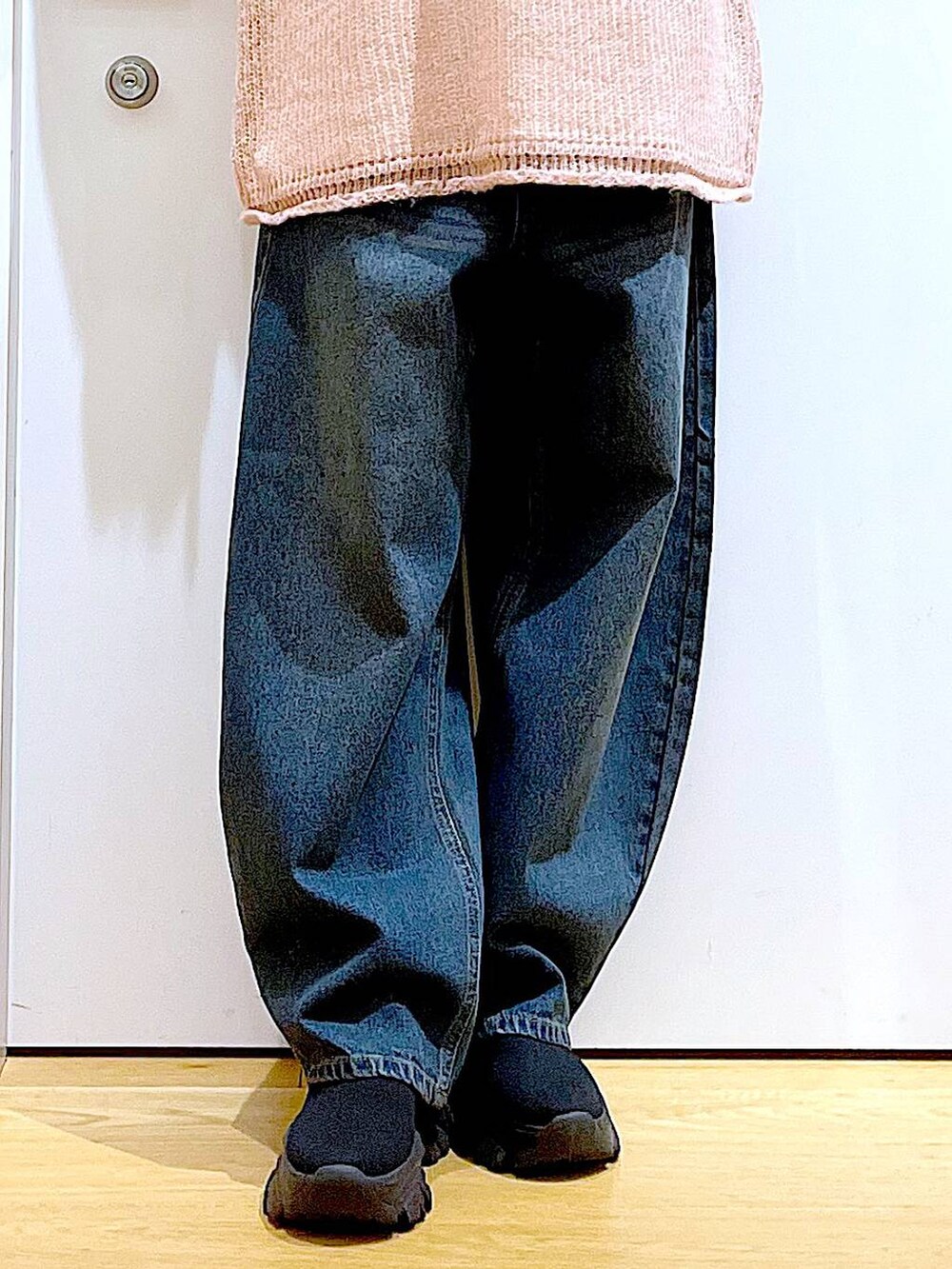 ブラック系のショルダーバッグ、ブラック系のブーツ、ピンク系のニット/セーターを着用したレディースの冬コーディネートの8枚目の写真