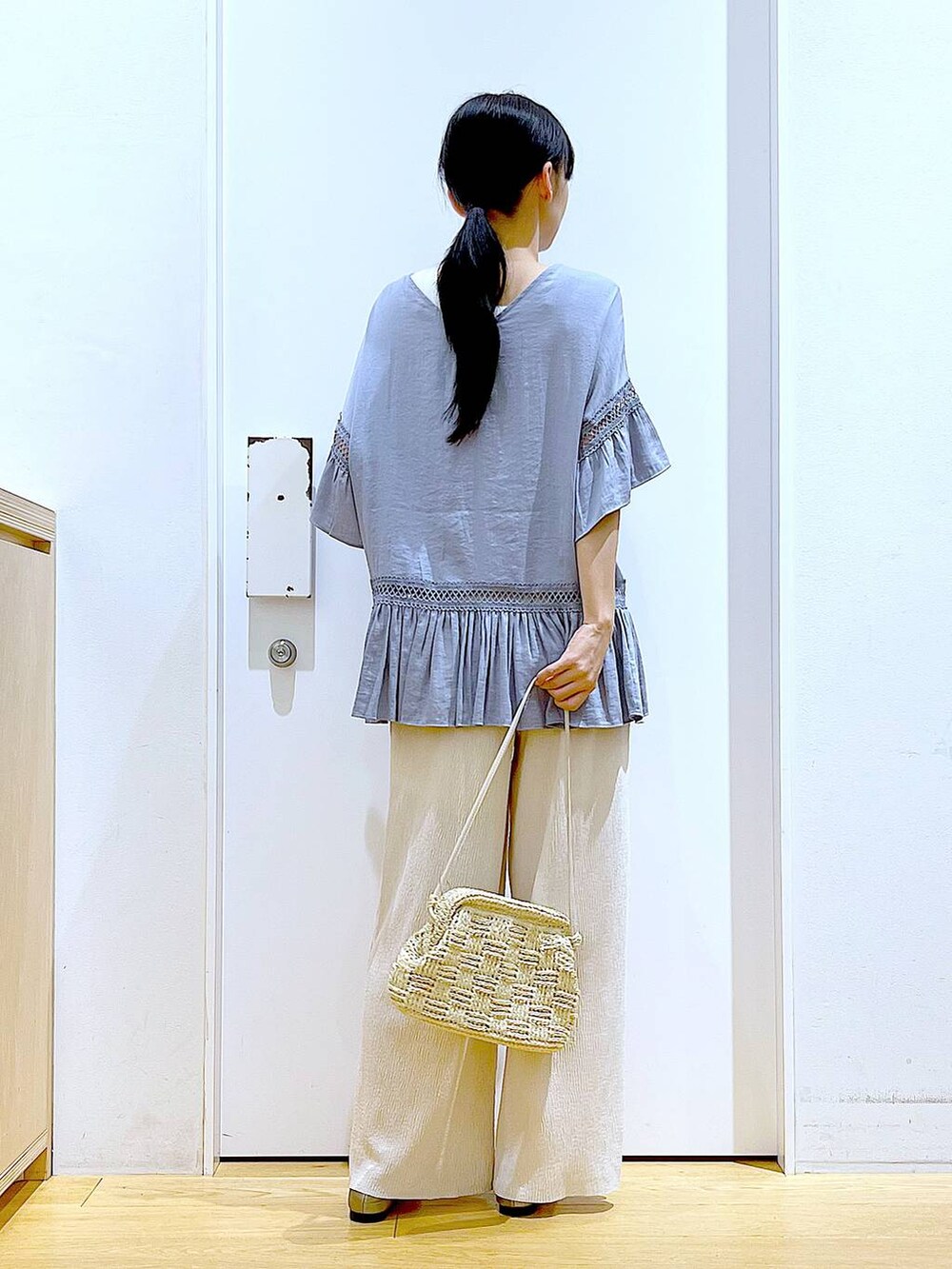 ブルー系のチュニック、その他のパンプス、ホワイト系のショルダーバッグを着用したレディースの春コーディネートの5枚目の写真