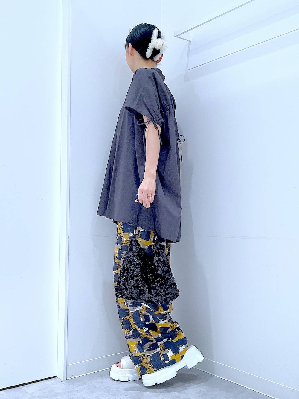 グレー系のその他パンツ、ブラック系のショルダーバッグ、ホワイト系のサンダルを着用したレディースの夏コーディネートの3枚目の写真