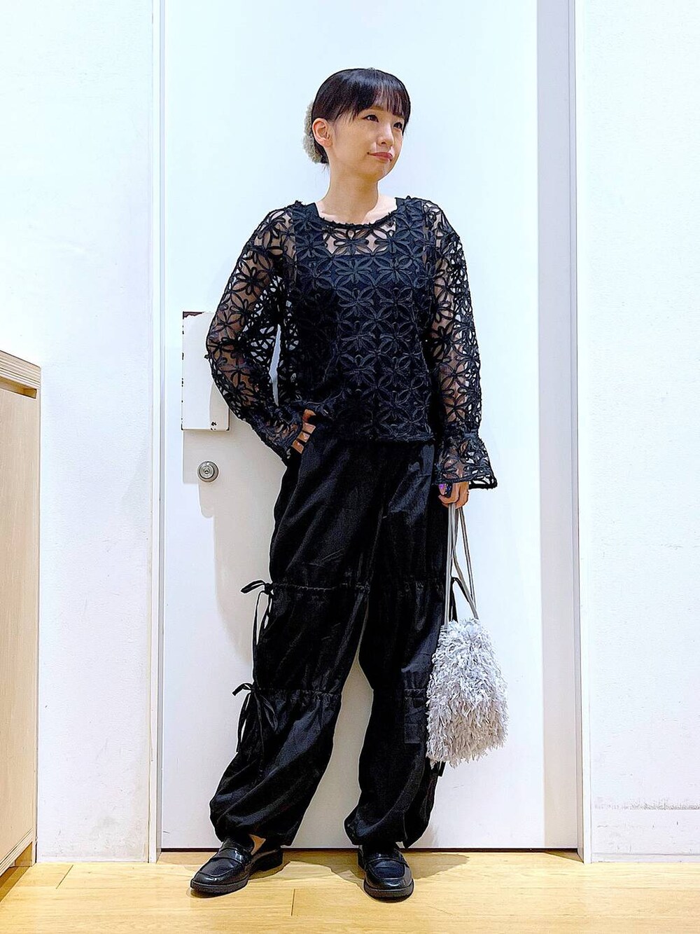 グレー系のショルダーバッグ、ブラック系のローファー、ブラック系のニット/セーターを着用したレディースの秋コーディネートの2枚目の写真