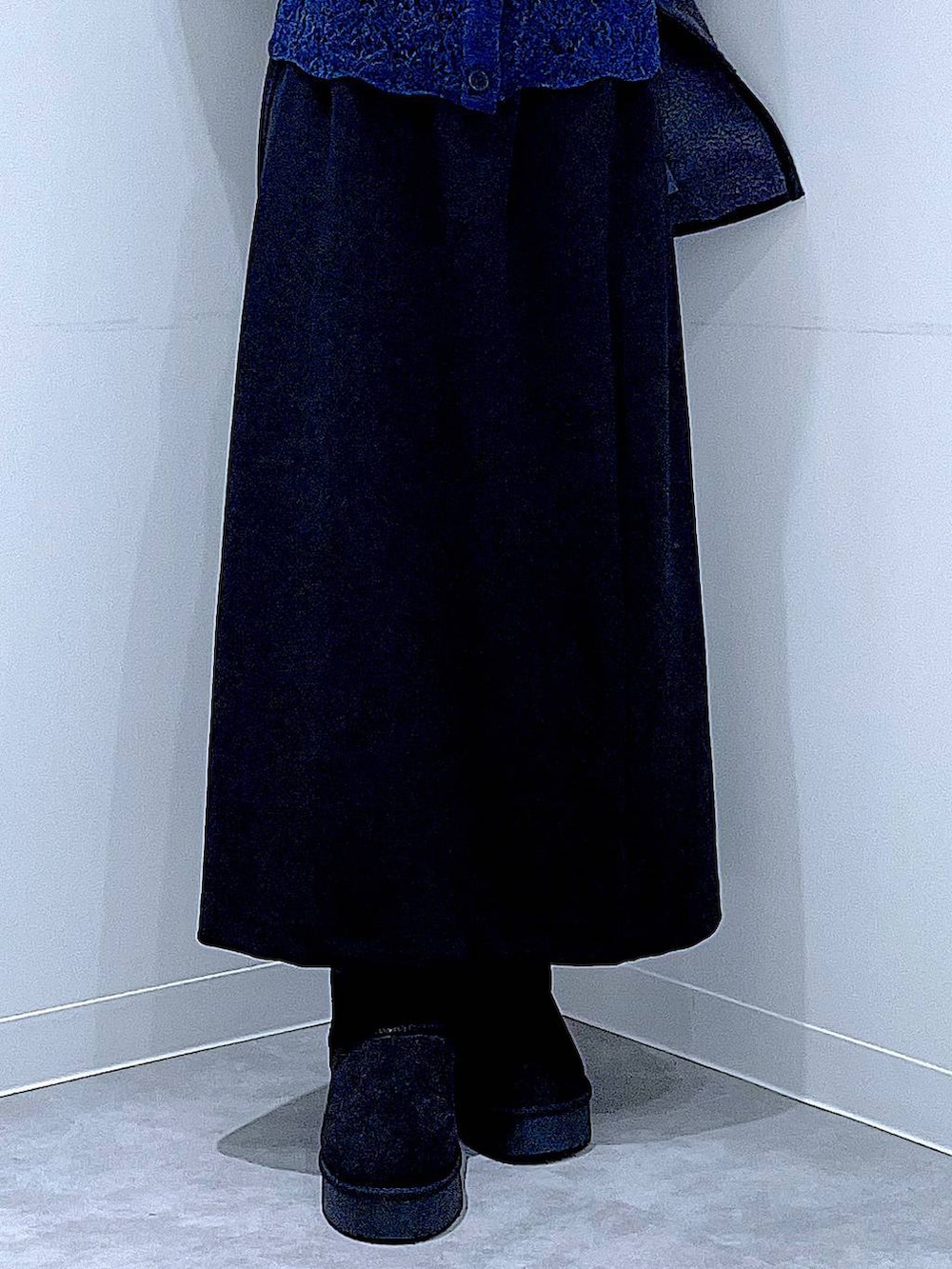 ブラック系のスカート、グレー系のブルゾン、ブラック系のブーツを着用したレディースの秋コーディネートの8枚目の写真