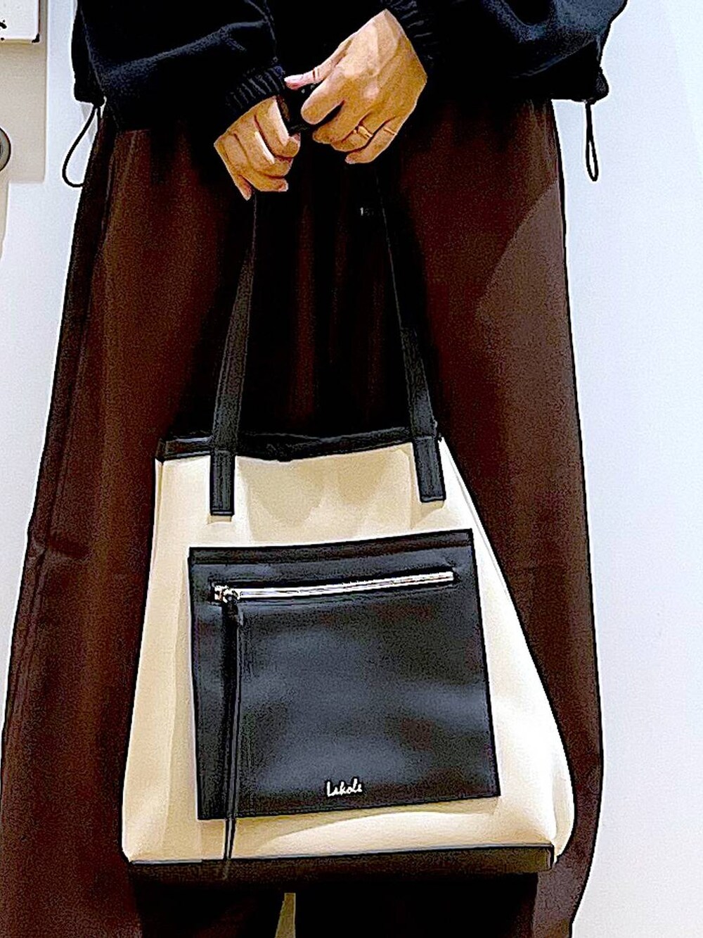 ブラック系のスリッポン、ブラウン系のその他パンツ、ホワイト系のトートバッグを着用したレディースの秋コーディネートの9枚目の写真