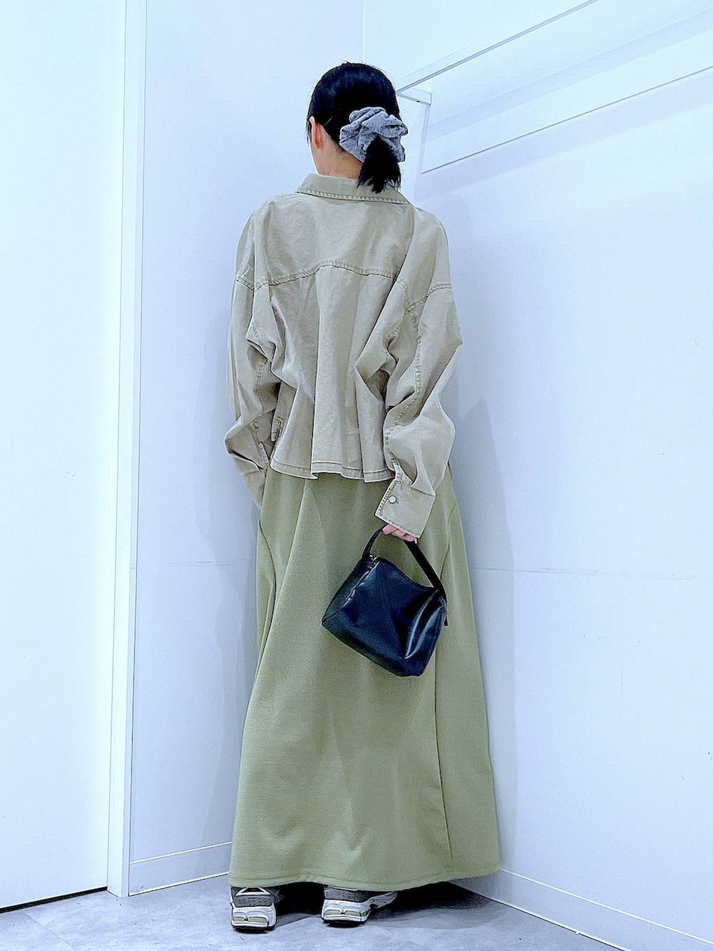 ブラック系のTシャツ/カットソー、ブラック系のショルダーバッグ、ベージュ系のシャツ/ブラウスを着用したレディースの冬コーディネートの5枚目の写真