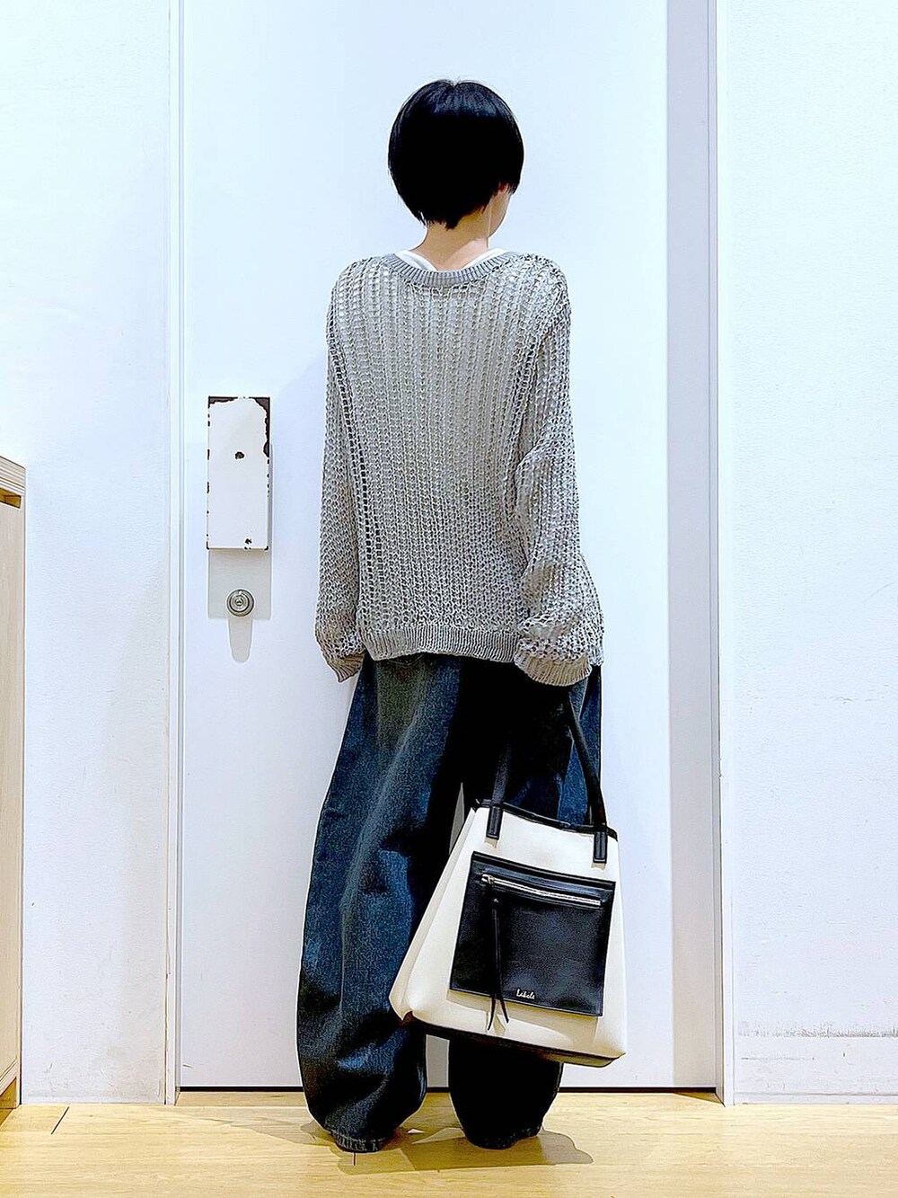 ブルー系のデニムパンツ、ホワイト系のトートバッグ、シルバー系のパンプスを着用したレディースの春コーディネートの5枚目の写真