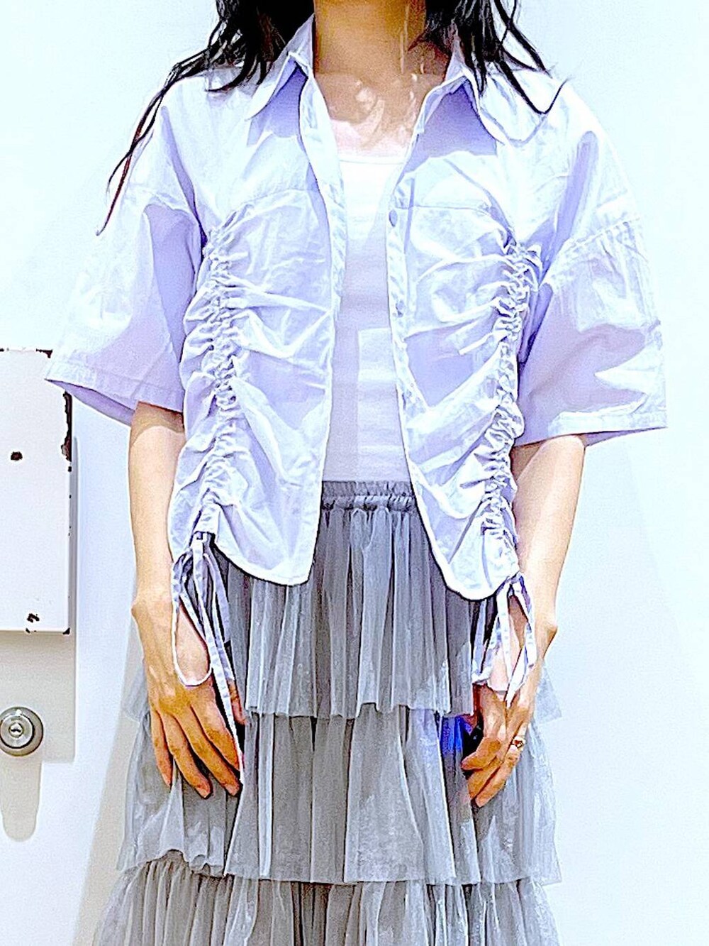 ブルー系のショルダーバッグ、ホワイト系のサンダル、グレー系のスカートを着用したレディースの夏コーディネートの7枚目の写真