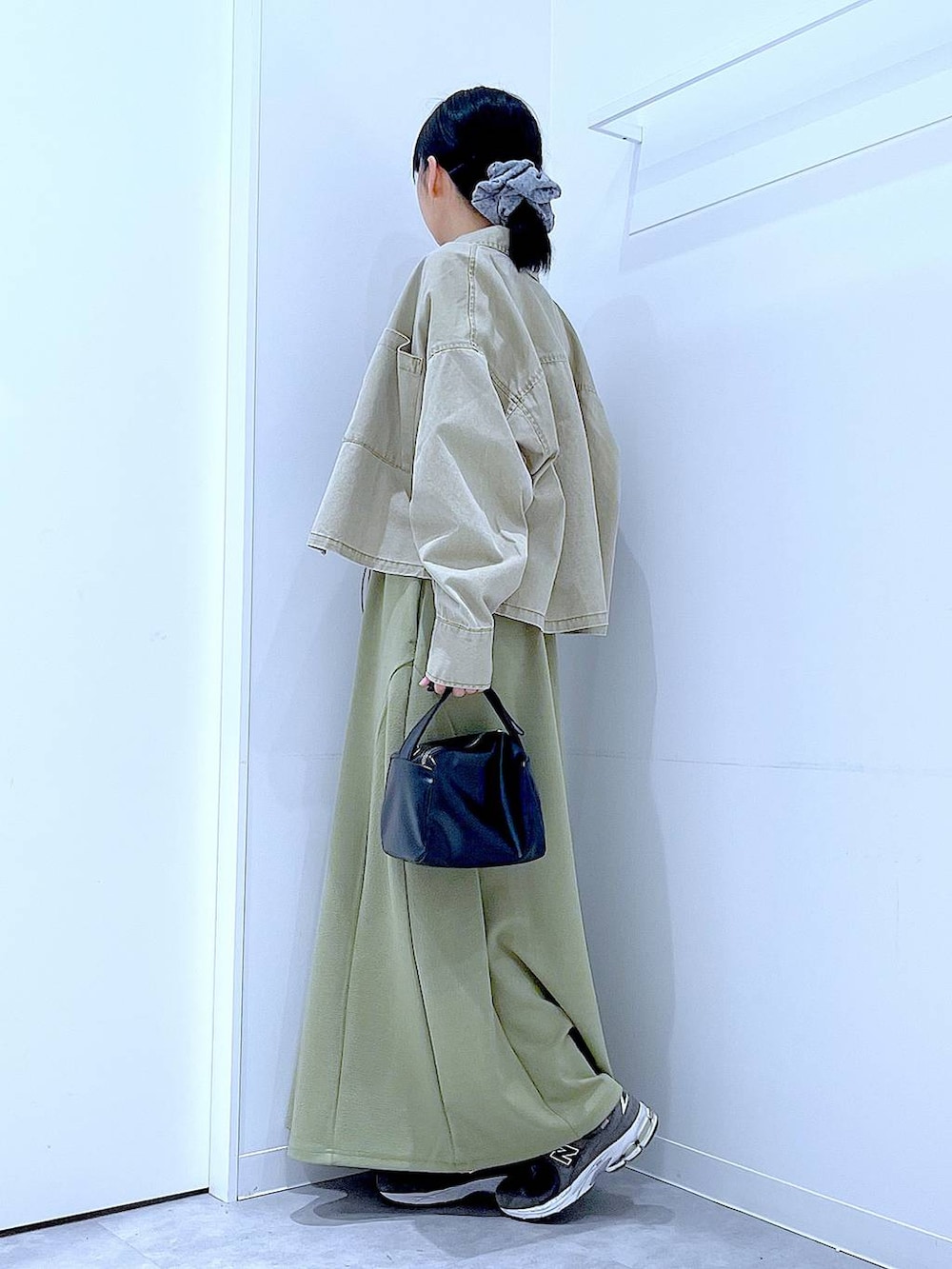 ブラック系のTシャツ/カットソー、ブラック系のショルダーバッグ、ベージュ系のシャツ/ブラウスを着用したレディースの冬コーディネートの3枚目の写真