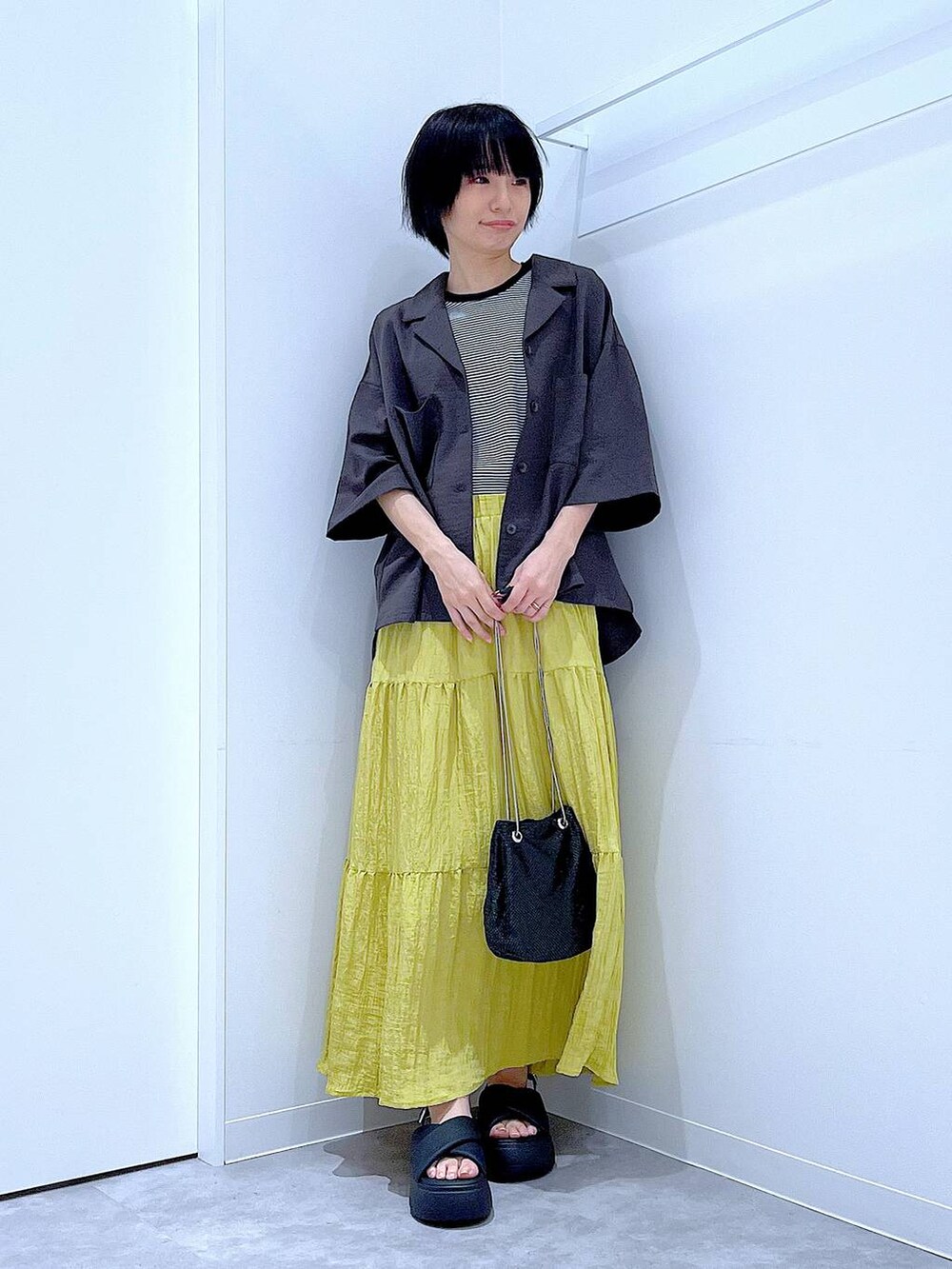 ブラック系のショルダーバッグ、その他のTシャツ/カットソー、ブラック系のサンダルを着用したレディースの夏コーディネートの2枚目の写真