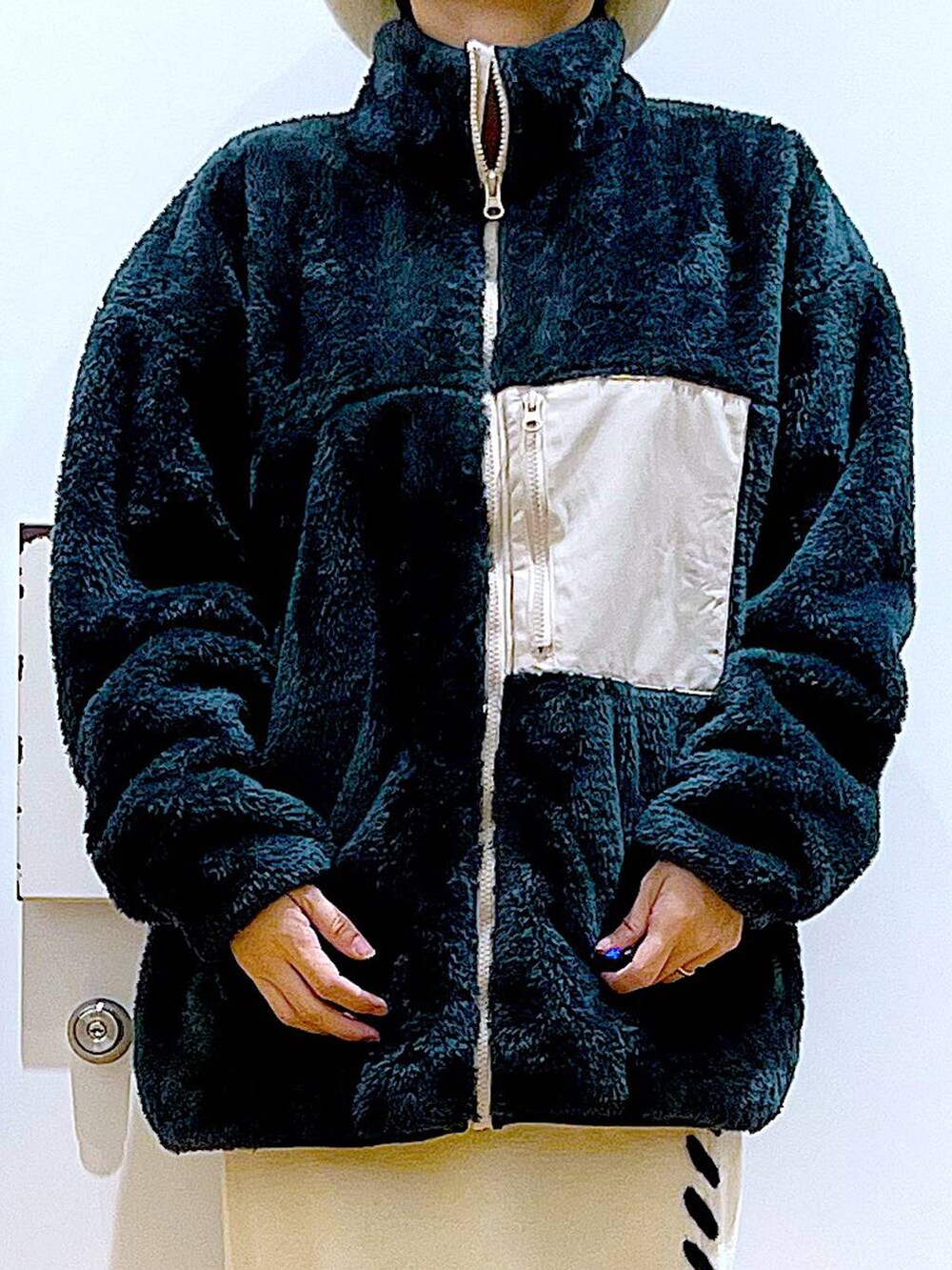 ブラック系のブーツ、ベージュ系のスカート、ブラック系のショルダーバッグを着用したレディースの冬コーディネートの7枚目の写真