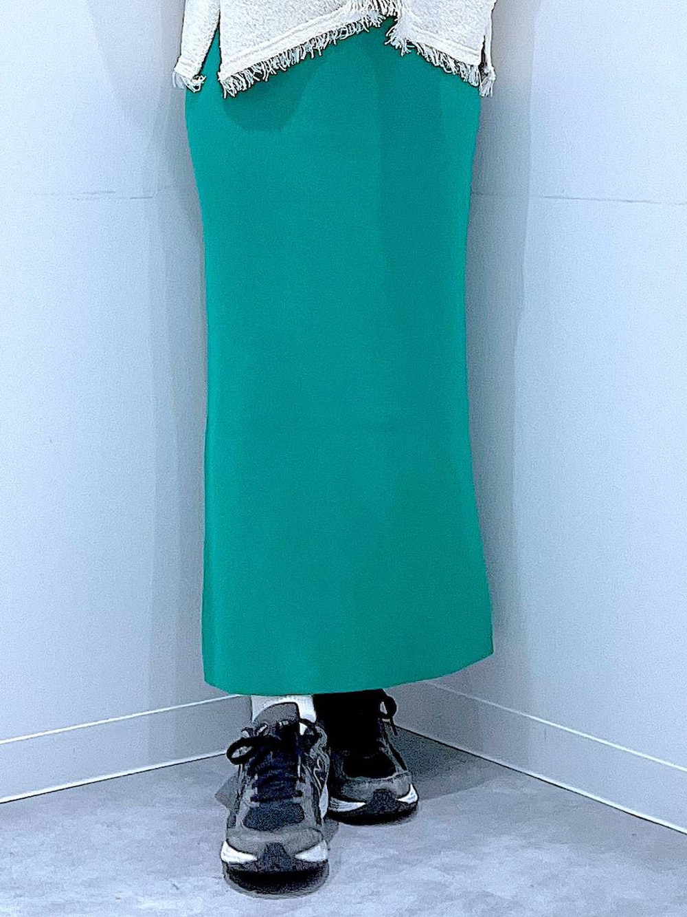 ブラック系のTシャツ/カットソー、グリーン系のスカート、ホワイト系のニット/セーターを着用したレディースの冬コーディネートの8枚目の写真