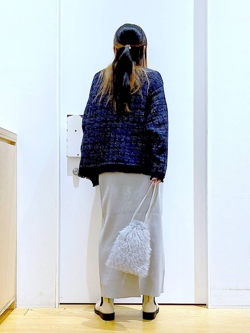 グレー系のTシャツ/カットソー、ブルー系のカーディガン/ボレロ、ベージュ系のブーツを着用したレディースの春コーディネートの5枚目の写真