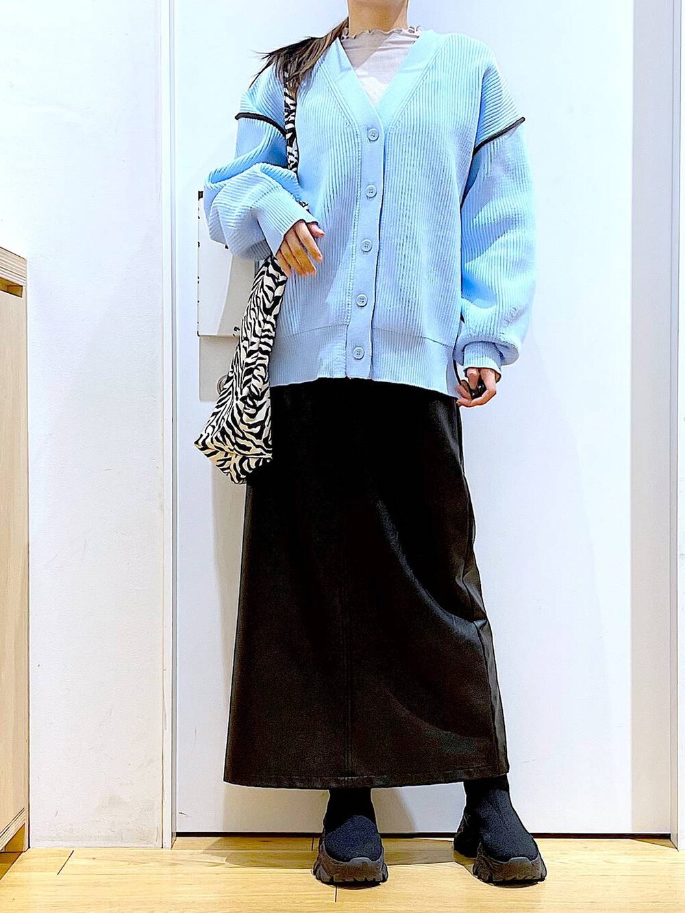 グレー系のTシャツ/カットソー、ブラック系のブーツ、その他のトートバッグを着用したレディースの春コーディネートの6枚目の写真