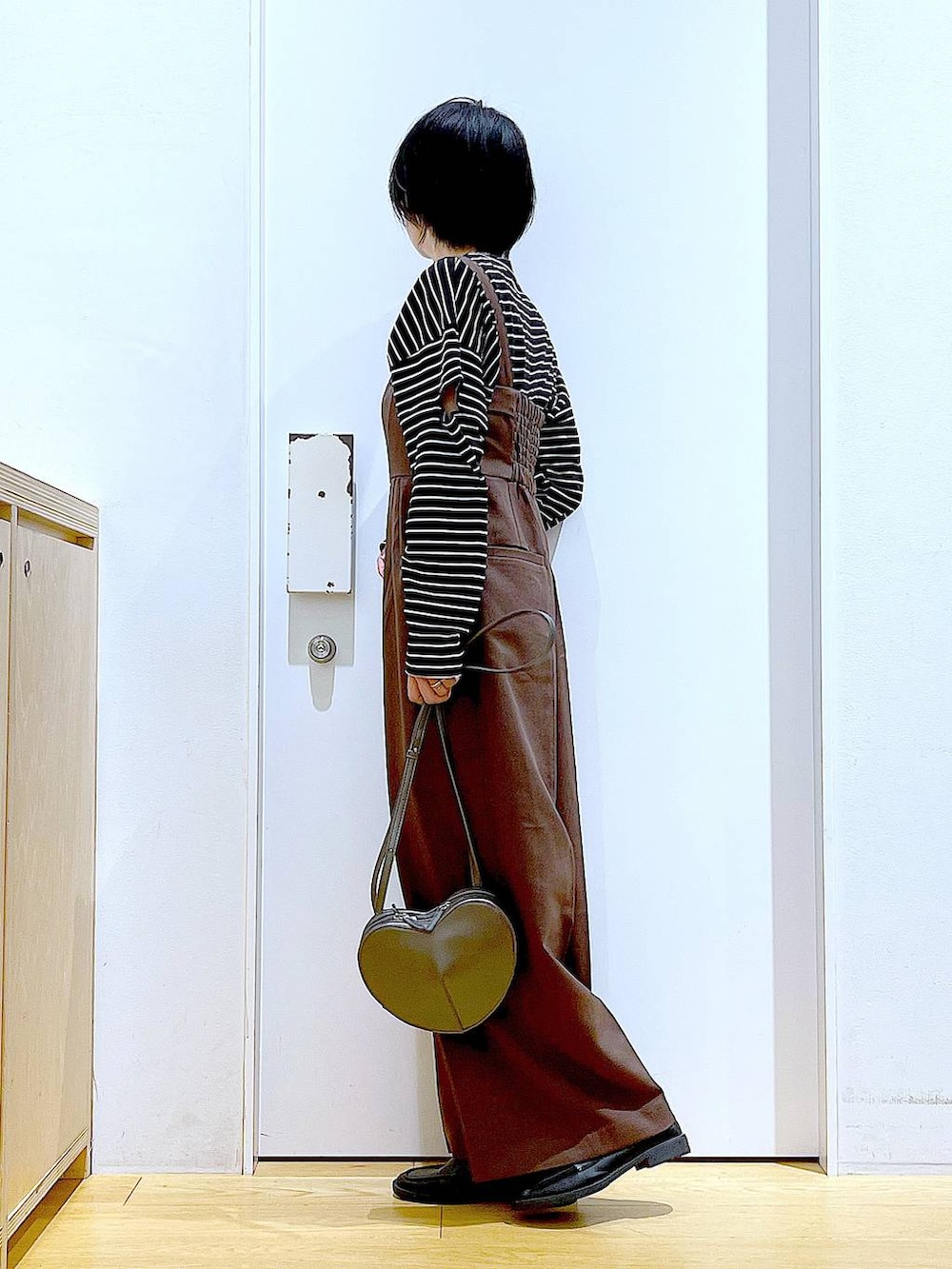 シルバー系のショルダーバッグ、ブラック系のローファー、ブラウン系のサロペット/オーバーオールを着用したレディースの秋コーディネートの3枚目の写真