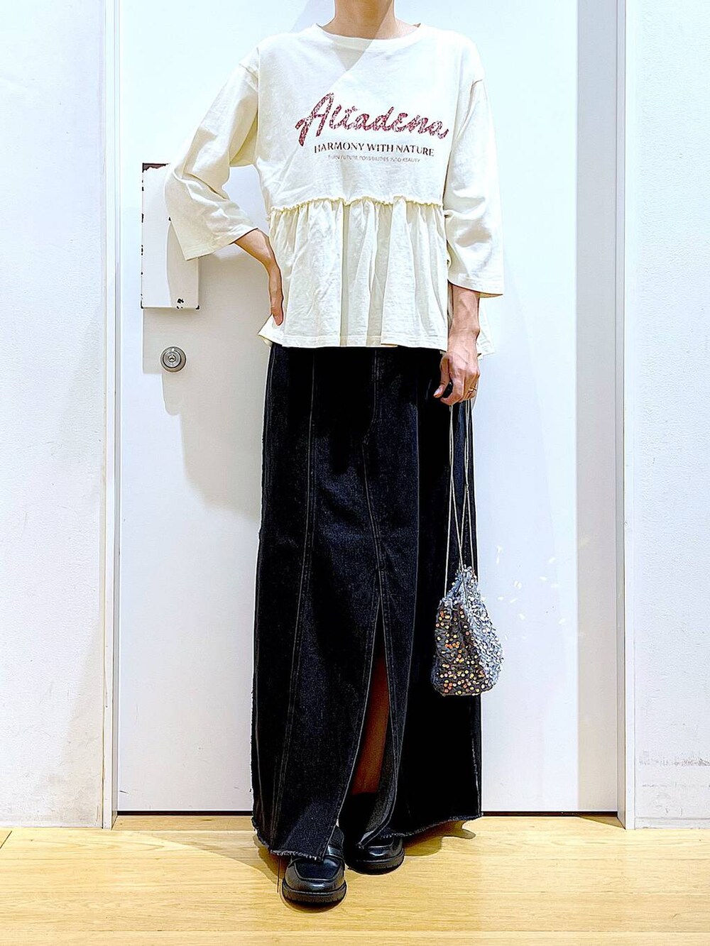 グレー系のショルダーバッグ、ブラック系のローファー、ベージュ系のTシャツ/カットソーを着用したレディースの秋コーディネートの6枚目の写真