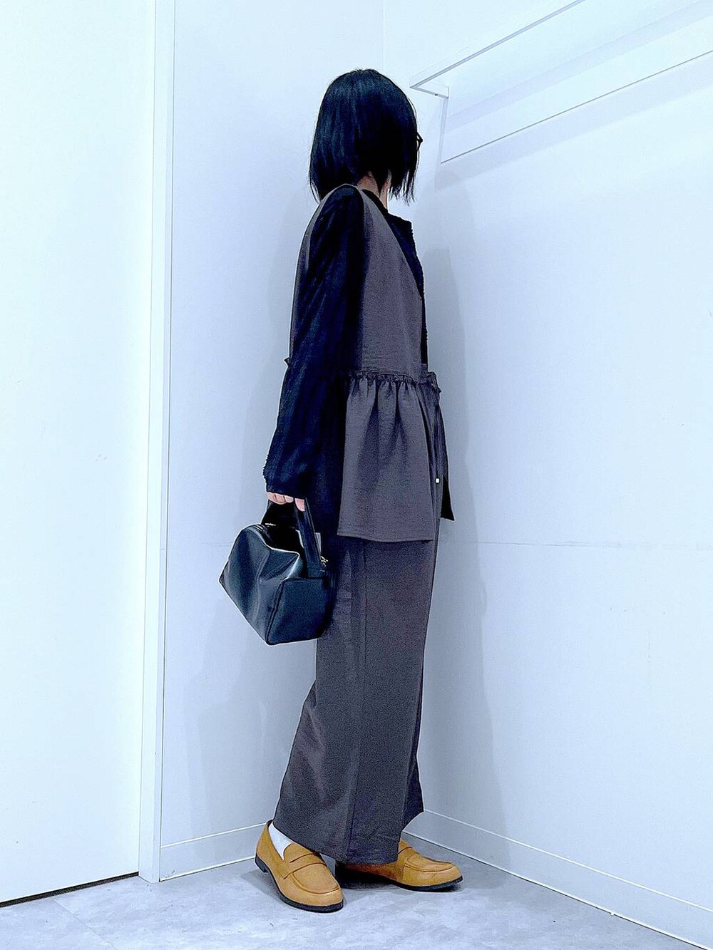 グレー系のその他パンツ、ブラック系のTシャツ/カットソー、ブラック系のショルダーバッグを着用したレディースの春コーディネートの4枚目の写真