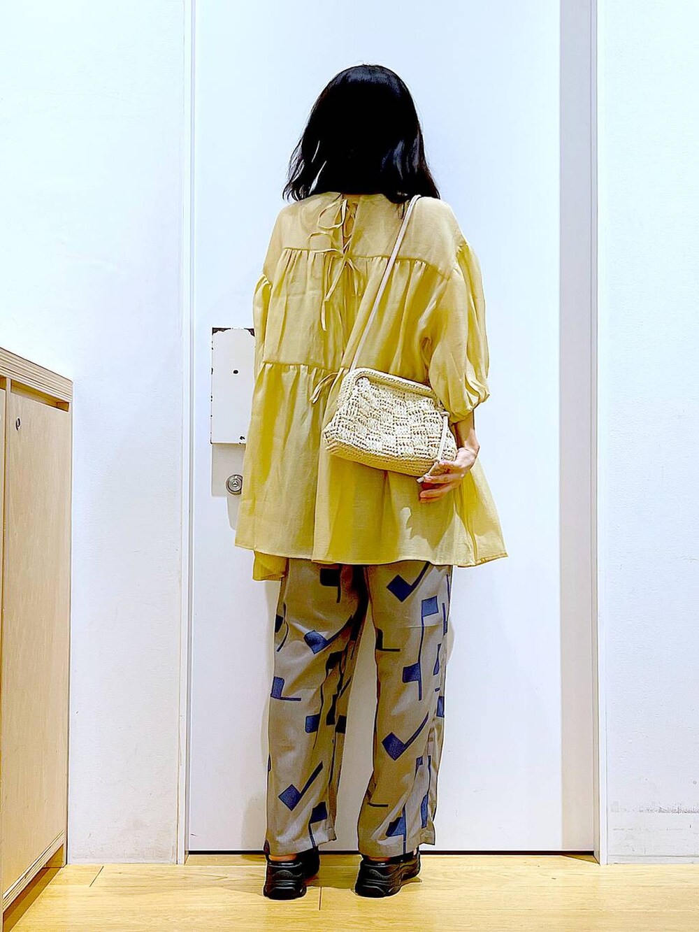 グレー系のその他パンツ、ホワイト系のショルダーバッグ、ブラック系のサンダルを着用したレディースの夏コーディネートの5枚目の写真