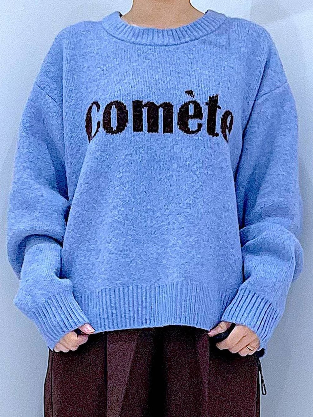 ブラック系のブーツ、ブラウン系のスラックス、ブラック系のショルダーバッグを着用したレディースの冬コーディネートの7枚目の写真