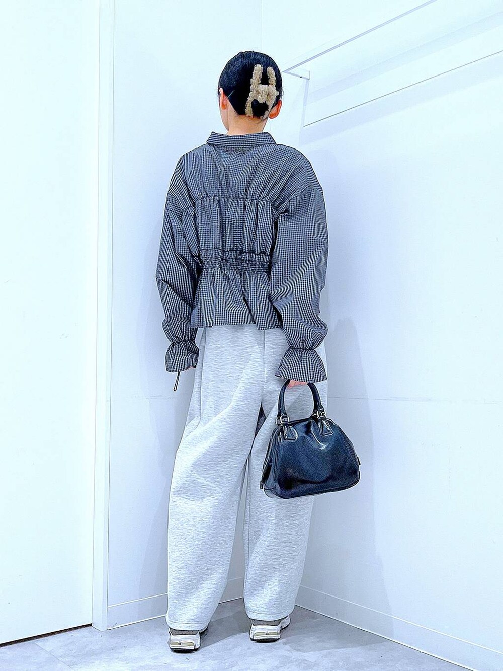 ブラック系のショルダーバッグ、グレー系のバレッタ/ヘアクリップを着用したレディースの春コーディネートの5枚目の写真