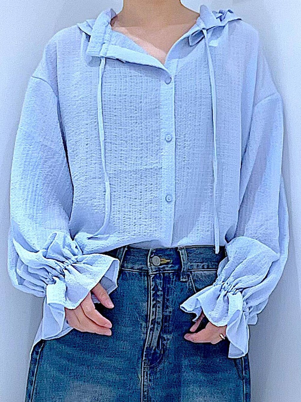 ブルー系のデニムパンツ、ベージュ系のローファー、ホワイト系のトートバッグを着用したレディースの春コーディネートの7枚目の写真