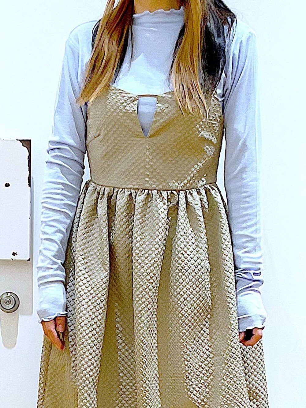 ブルー系のTシャツ/カットソー、ブラウン系のワンピース、ベージュ系のブーツを着用したレディースの冬コーディネートの7枚目の写真