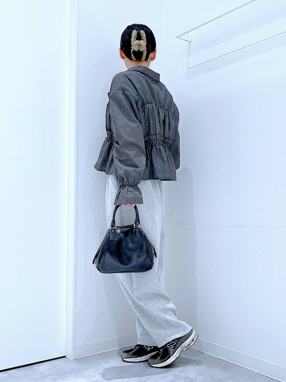 ブラック系のショルダーバッグ、グレー系のバレッタ/ヘアクリップを着用したレディースの春コーディネートの3枚目の写真