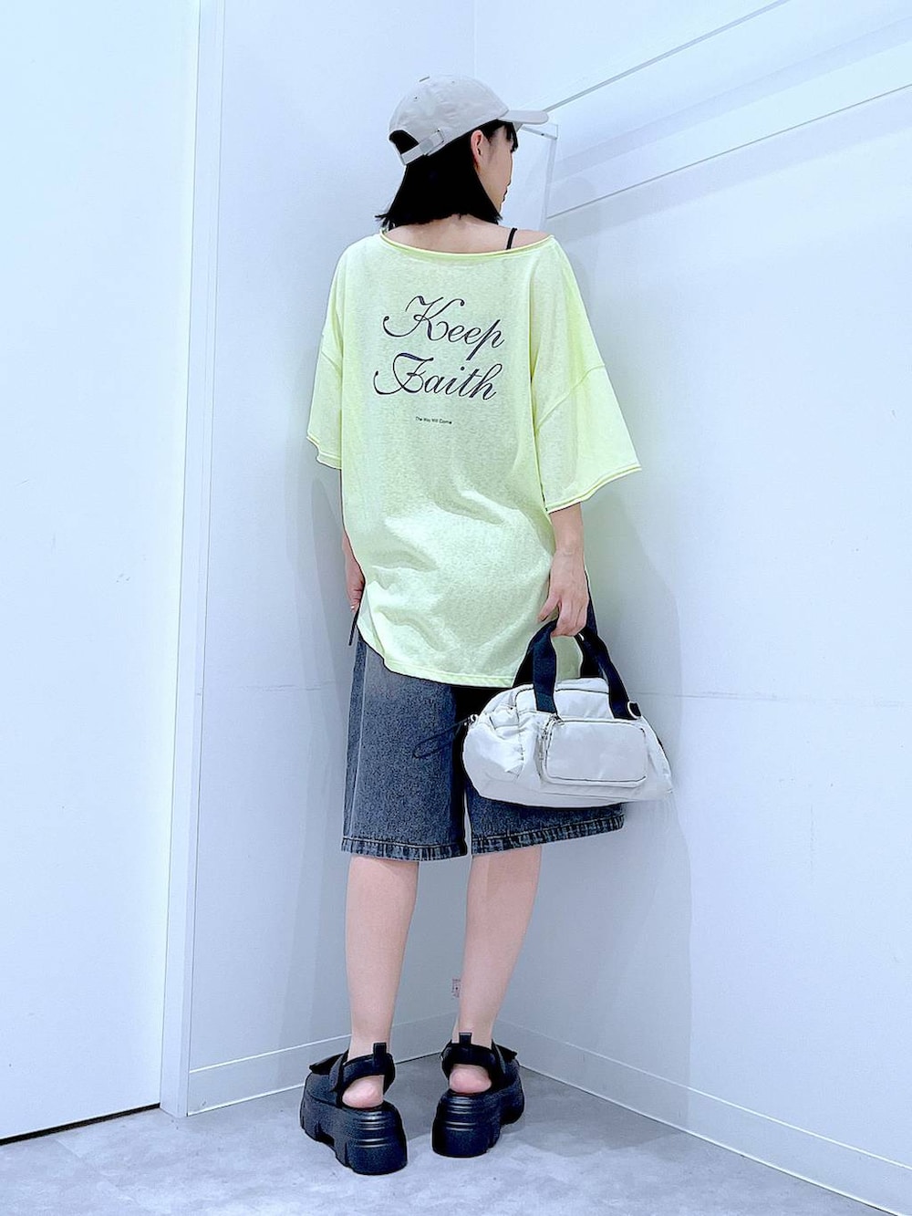 ブラック系のサンダル、ホワイト系のショルダーバッグ、イエロー系のTシャツ/カットソーを着用したレディースの夏コーディネートの5枚目の写真