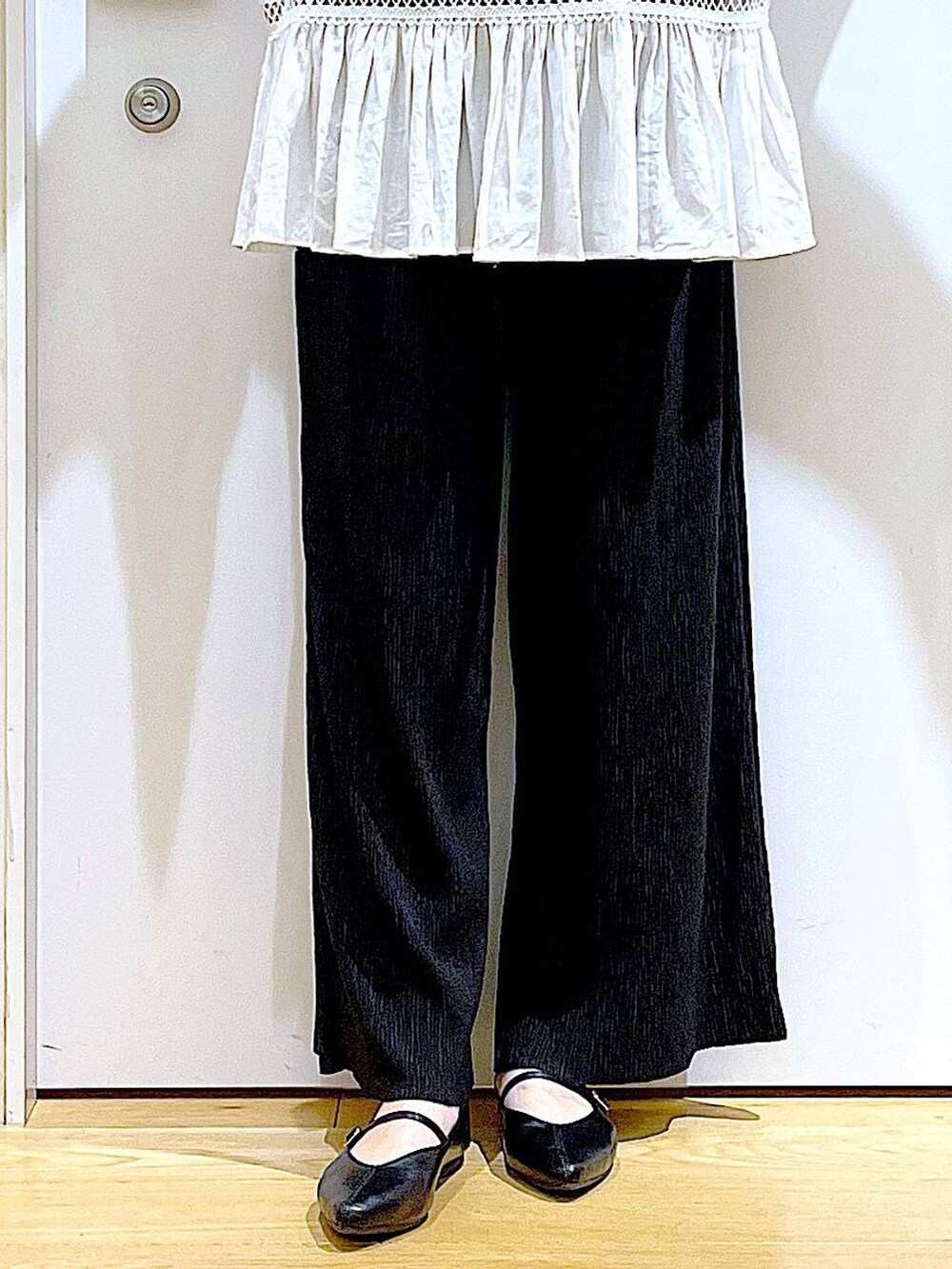 ホワイト系のチュニック、ブラック系のその他パンツ、ブラック系のパンプスを着用したレディースの夏コーディネートの8枚目の写真