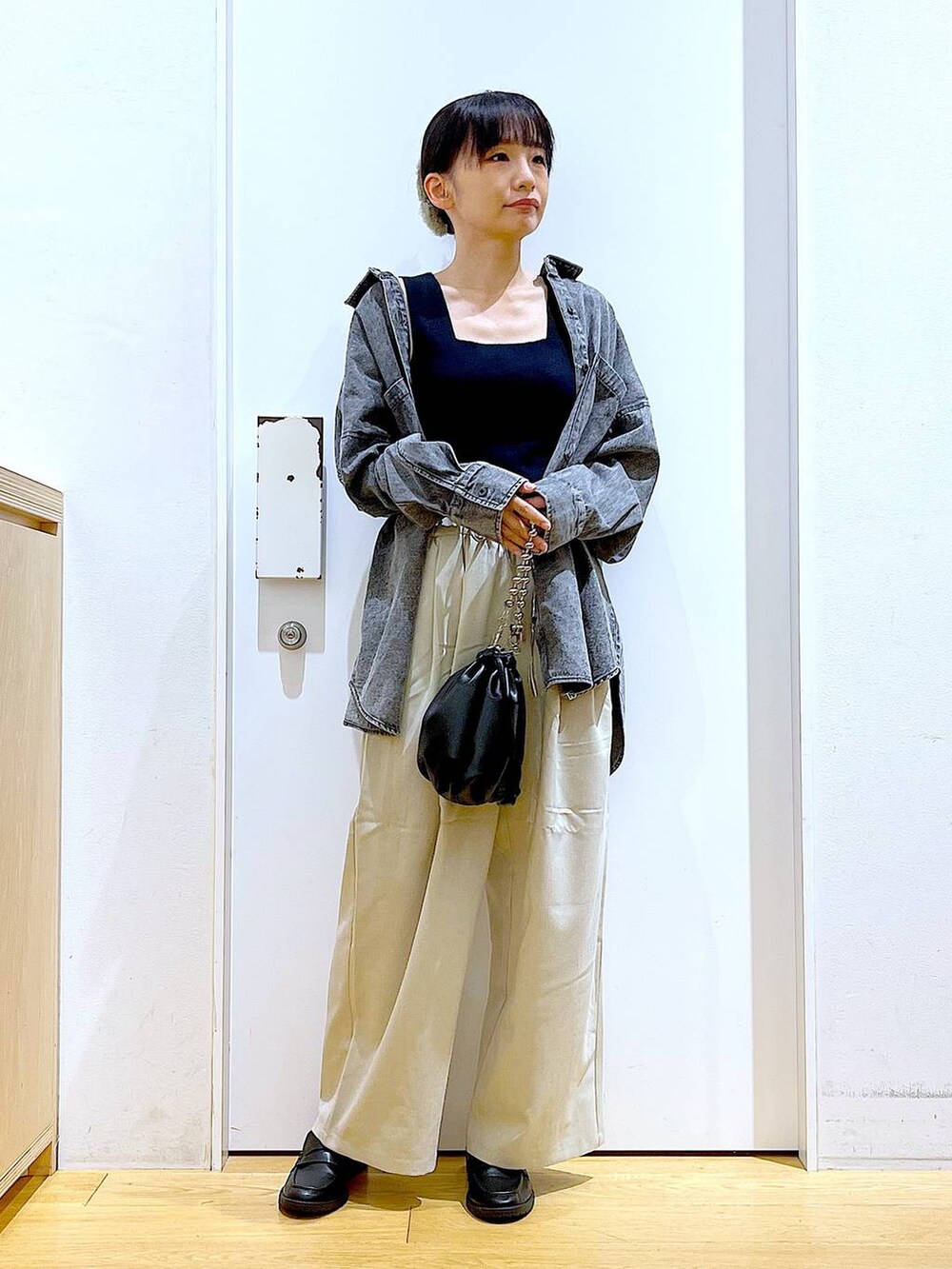 ブラック系のショルダーバッグ、ブラック系のローファー、ブラック系のニット/セーターを着用したレディースの秋コーディネートの2枚目の写真