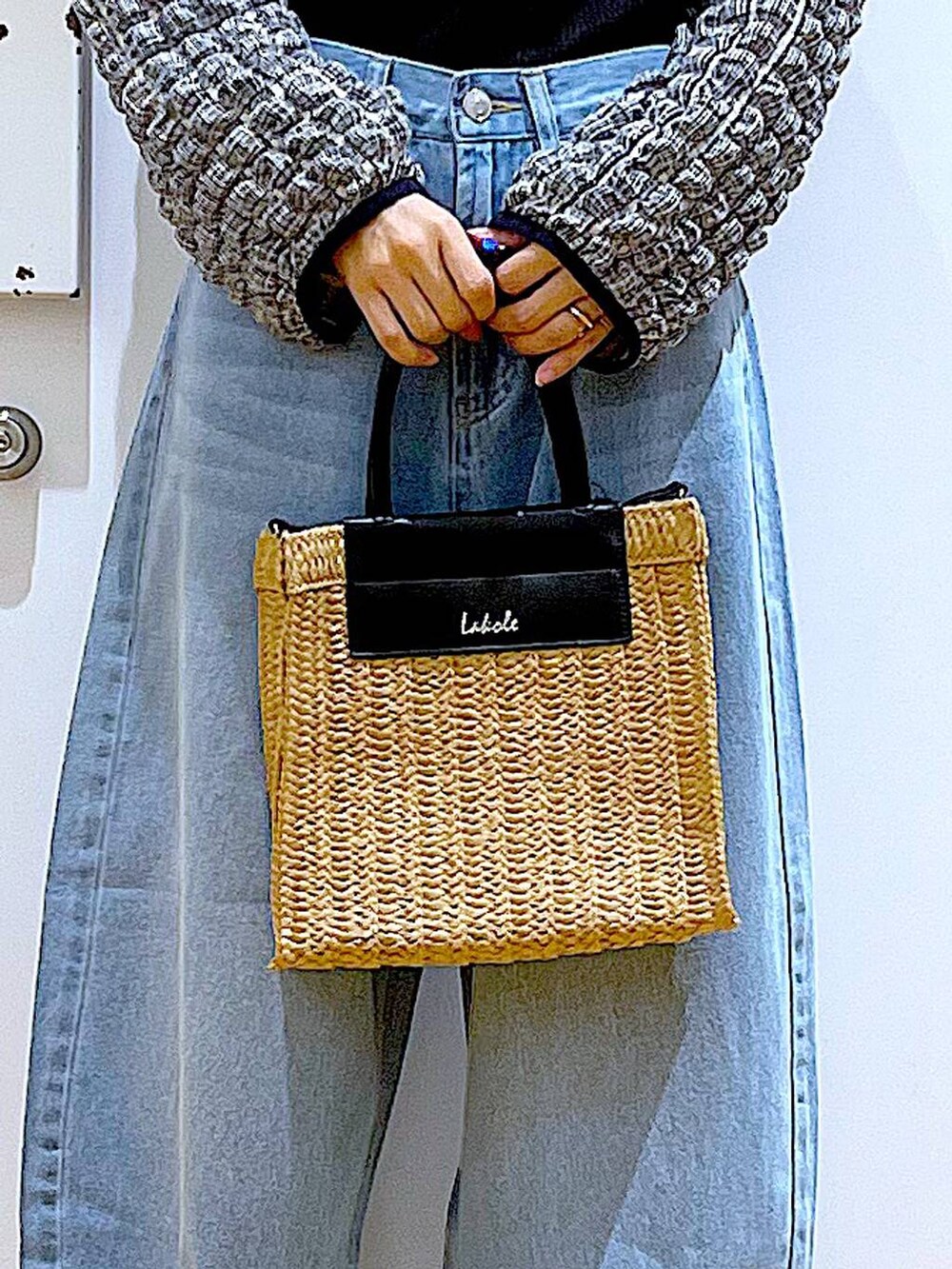 ブルー系のデニムパンツ、ブラック系のTシャツ/カットソー、ベージュ系のショルダーバッグを着用したレディースの夏コーディネートの9枚目の写真