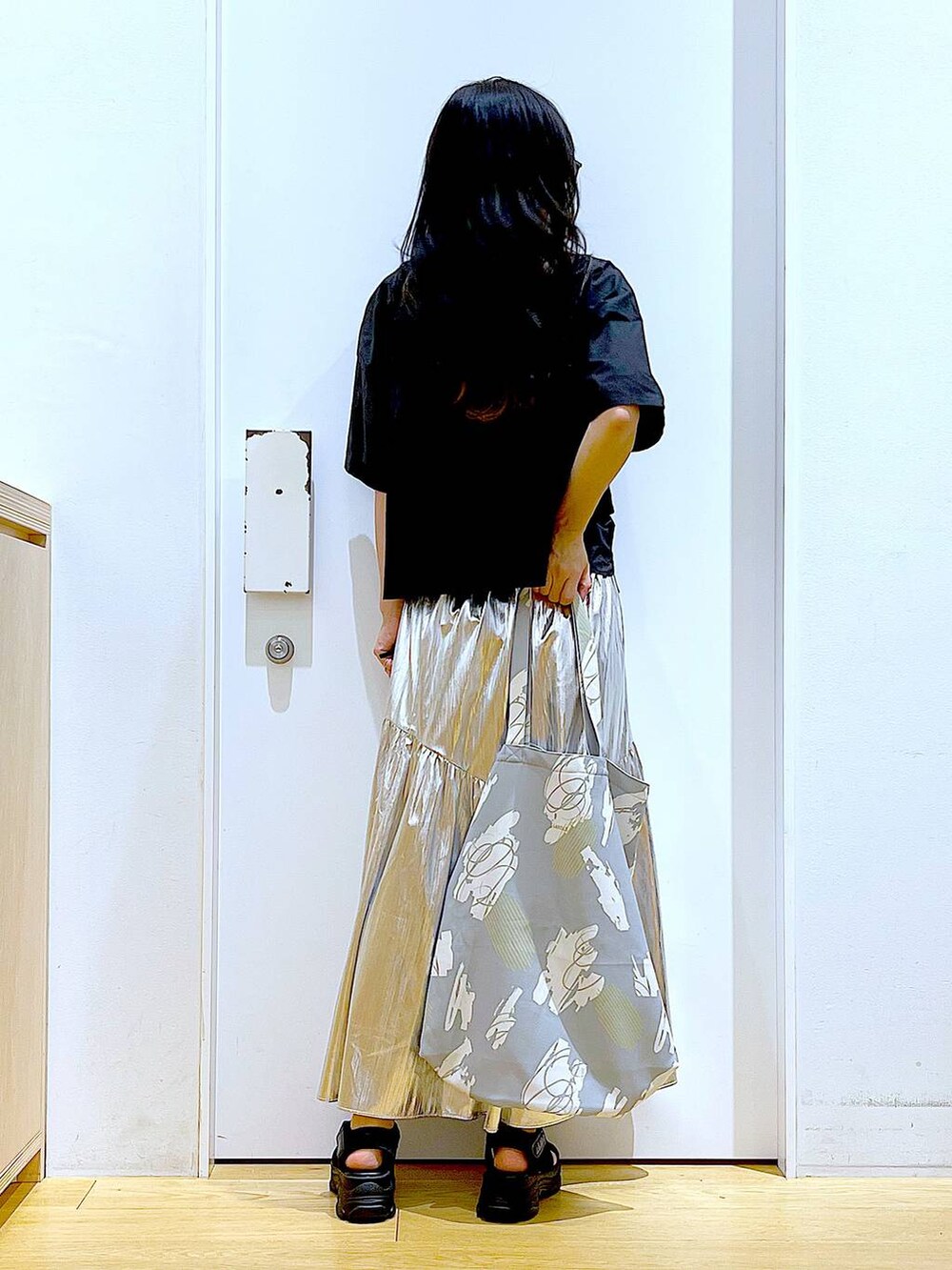 ブラック系のサンダル、グレー系のシャツ/ブラウス、グレー系のトートバッグを着用したレディースの夏コーディネートの5枚目の写真