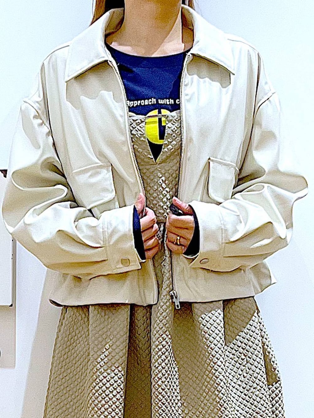 ベージュ系のブルゾン、ブラウン系のワンピース、ブルー系のTシャツ/カットソーを着用したレディースの春コーディネートの7枚目の写真