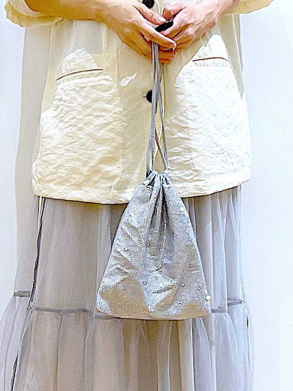 ホワイト系のサンダル、グレー系のショルダーバッグ、ホワイト系のニット/セーターを着用したレディースの夏コーディネートの9枚目の写真