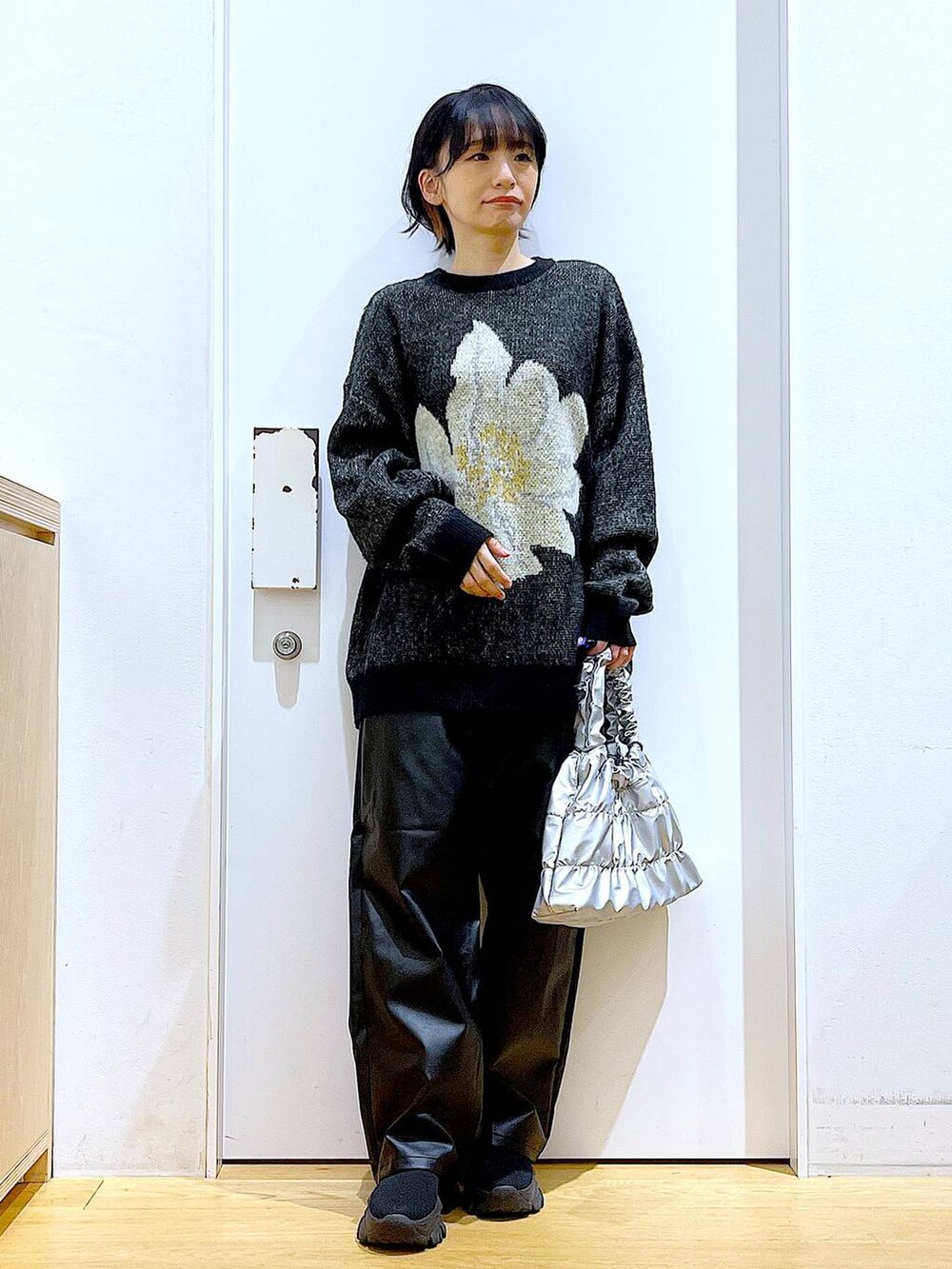 ブラック系のブーツ、ブラック系のその他パンツ、シルバー系のショルダーバッグを着用したレディースの冬コーディネートの2枚目の写真