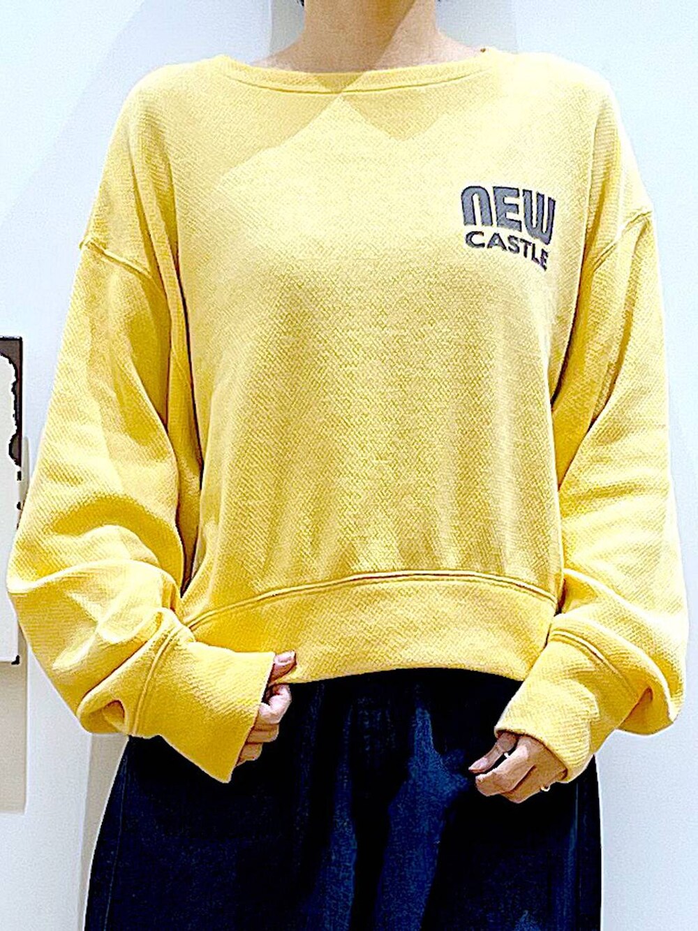 ホワイト系のパンプス、ブルー系のデニムパンツ、その他のトートバッグを着用したレディースの冬コーディネートの7枚目の写真