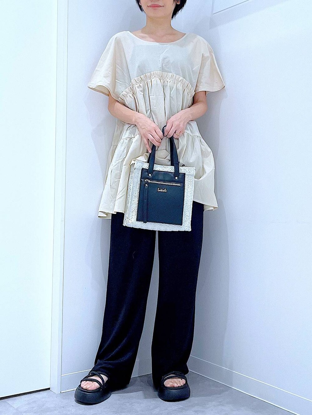 ホワイト系のショルダーバッグ、ブラック系のサンダル、ブラック系のその他パンツを着用したレディースの夏コーディネートの6枚目の写真