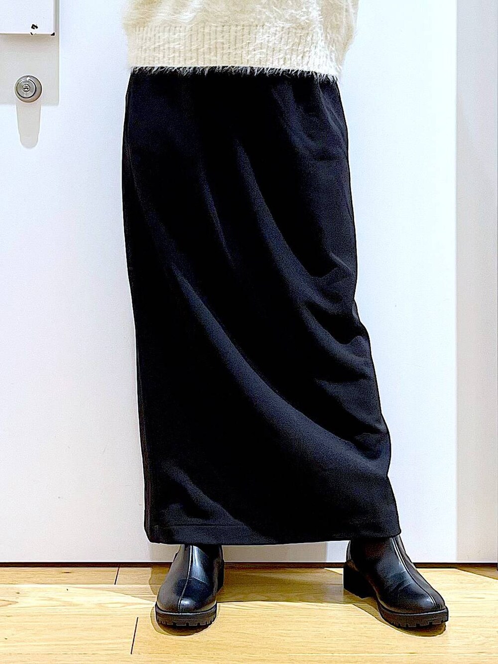 ブラック系のブーツ、シルバー系のトートバッグ、ベージュ系のニット/セーターを着用したレディースの冬コーディネートの8枚目の写真