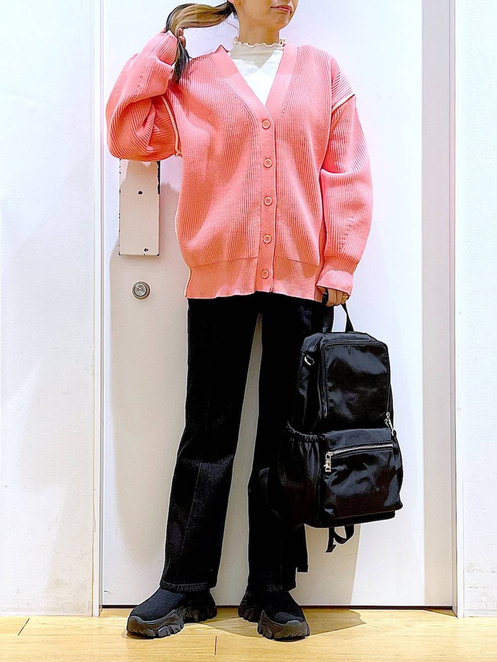 グレー系のデニムパンツ、ホワイト系のTシャツ/カットソー、ブラック系のバックパック/リュックを着用したレディースの冬コーディネートの6枚目の写真